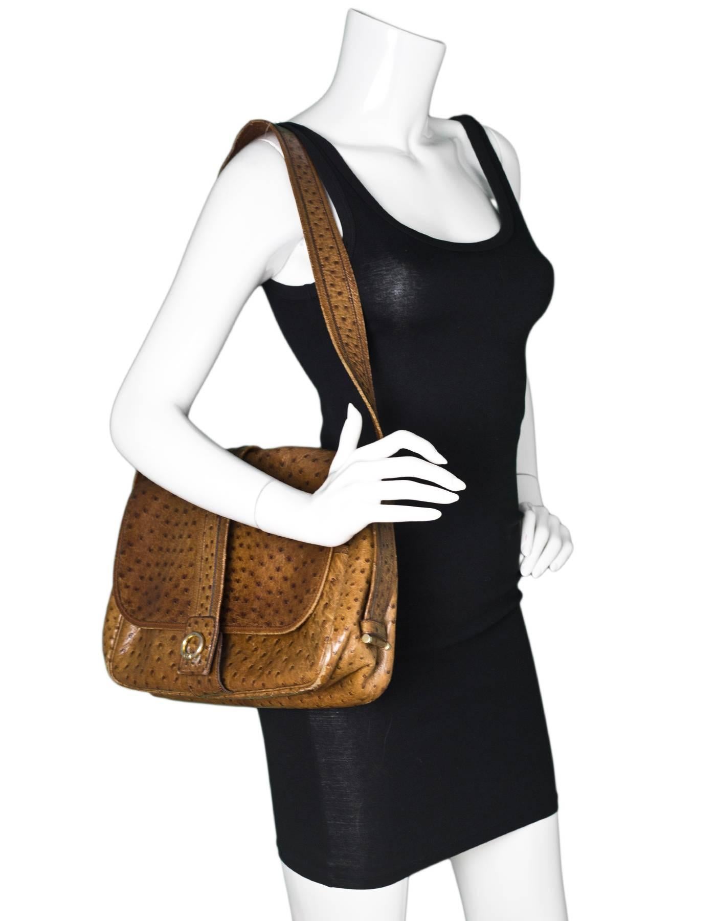 Hermes Vintage Brown Ostrich Shoulder Bag

Made In: France
Color: Brown
Hardware: Goldtone
Materials: Ostrich, metal
Lining: Brown leather
Closure/Opening: Flap top with snap
Exterior Pockets: Zip pocket at back
Interior Pockets: Three compartments,