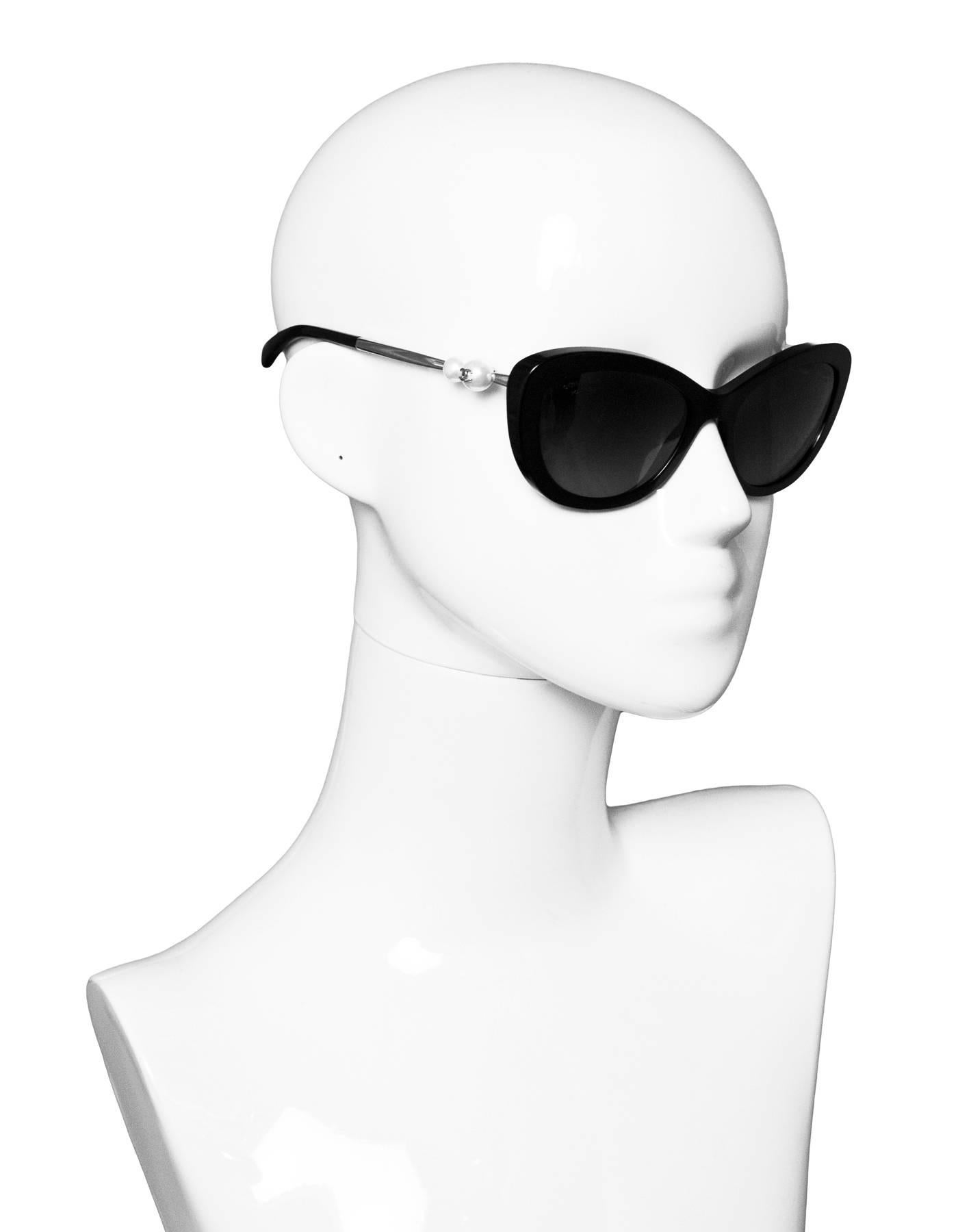 Chanel Black Cat-Eye Sunglasses with Pearl Arms
Feature polarized lenses

Made In: Italy
Color: Black, ivory, silver
Materials: Resin, metal, faux pearls
Retail Price: $650 + tax
Overall Condition: Excellent pre-owned condition
Included: Chanel box,