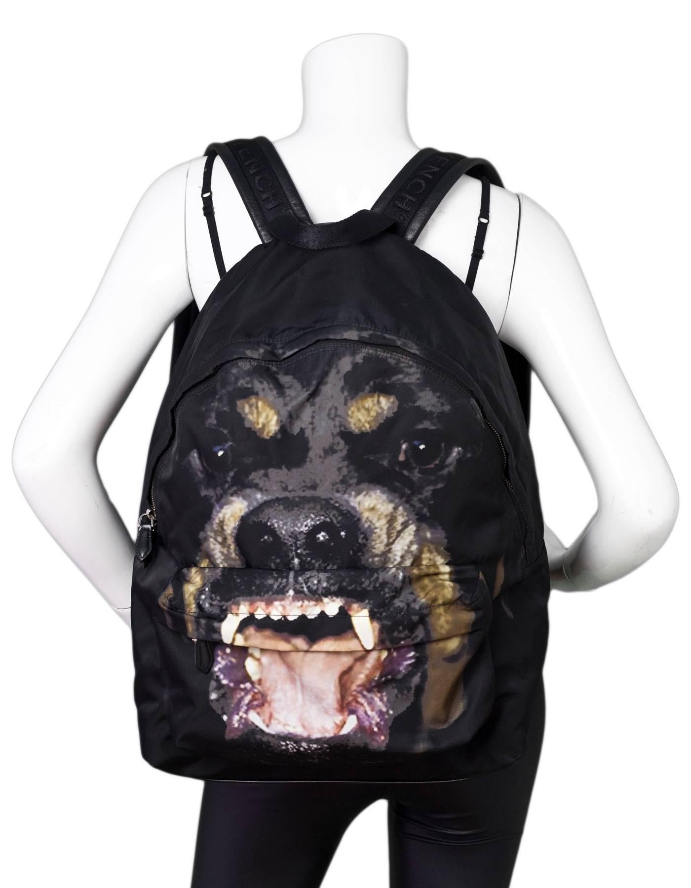Givenchy Black Rottweiler Backpack

Made In: Romania
Color: Black
Hardware: Silvertone
Materials: Nylon, leather, canvas
Lining: Black textile
Closure/Opening: Double zip closure
Exterior Pockets: Front zip pocket
Interior Pockets: One zip