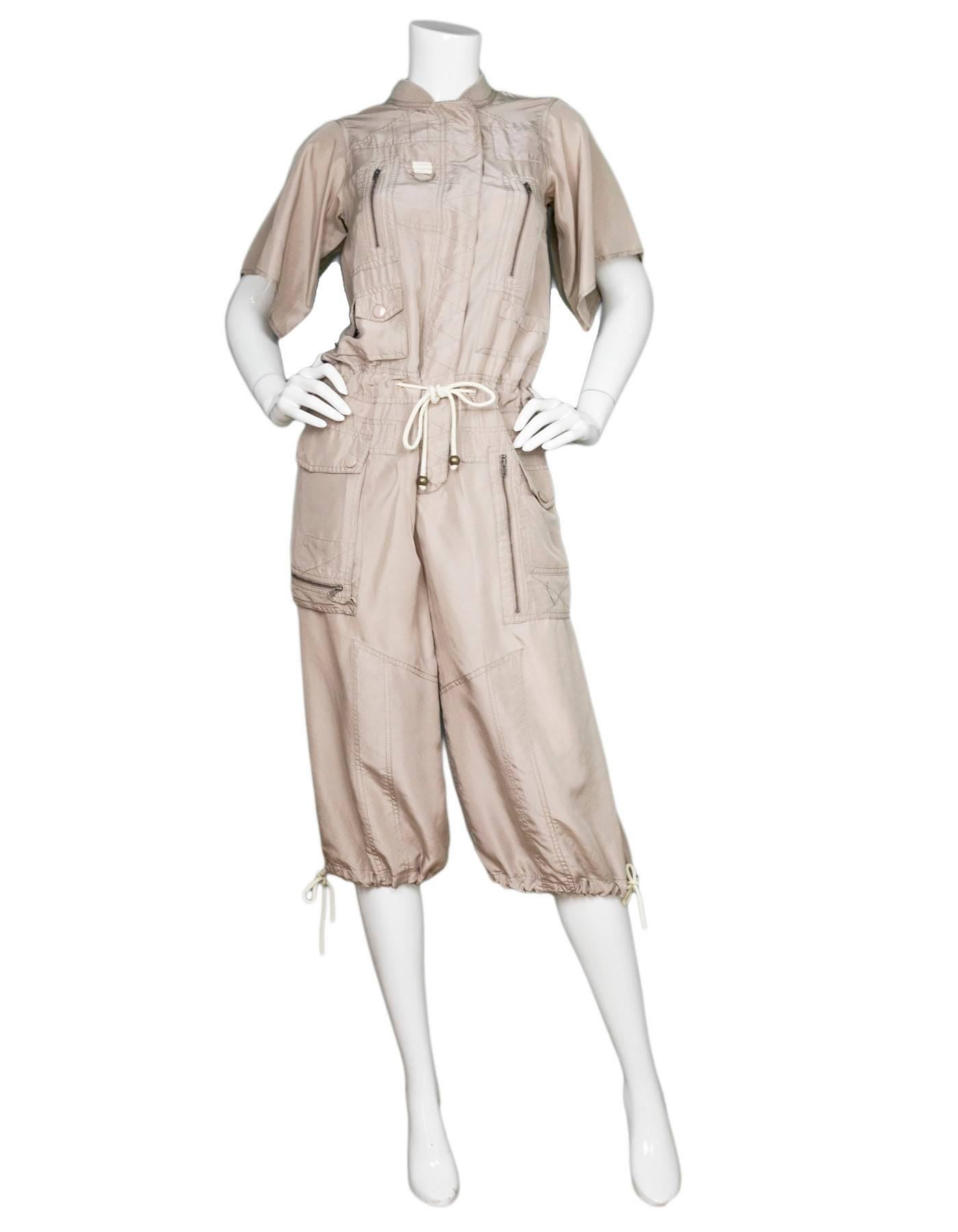 Marc Jacobs Taupe Silk Jumpsuit Sz XS

Made In: China
Color: Taupe
Composition: 100% silk
Closure/Opening: Front button closure
Exterior Pockets: Zip and button pockets throughout
Overall Condition: Very good pre-owned condition, some stains at
