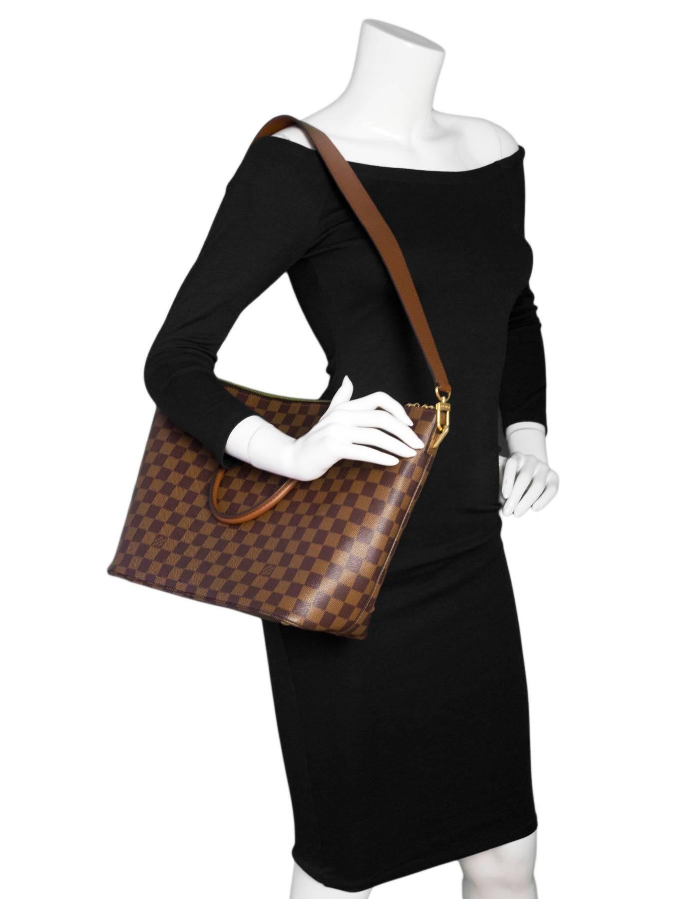 Louis Vuitton Damier Ebene Belmont Tote

Made In: France
Year of Production: 2014
Color: Brown
Hardware: Goldtone
Materials: Leather and coated canvas
Lining: Burgundy alacentra
Closure/Opening: Double zip across top
Exterior Pockets: None
Interior
