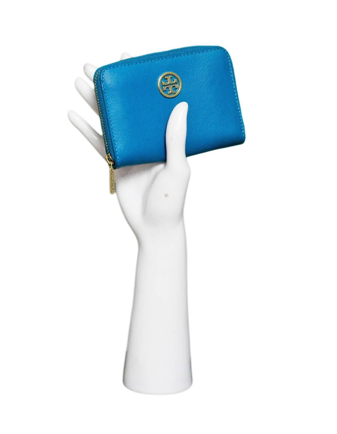 Tory Burch Blue Zip Around Coin Purse

Made In: China
Color: Blue
Materials: Leather, metal
Lining: Floral textile
Closure/Opening: Zip around closure
Exterior Pockets: None
Interior Pockets: Two compartments, two wall slots
Overall Condition: