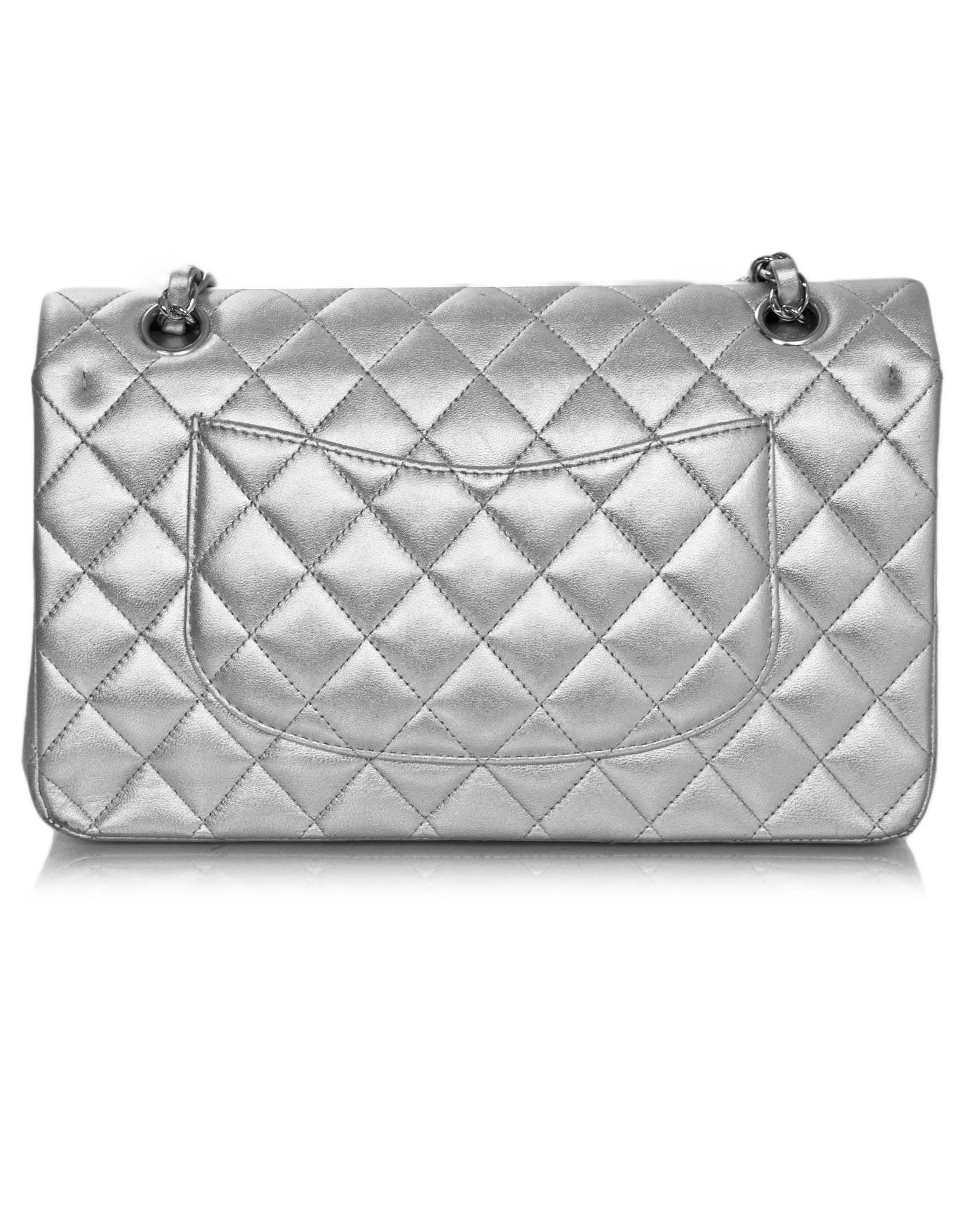 Chanel Silver Quilted Lambskin 10" Medium Double Flap Classic Bag

Made In: France
Year of Production: 2010-2011
Color: Silver
Hardware: Silvertone
Materials: Lambskin, metal
Lining: Silver leather
Closure/opening: Flap top with CC twist