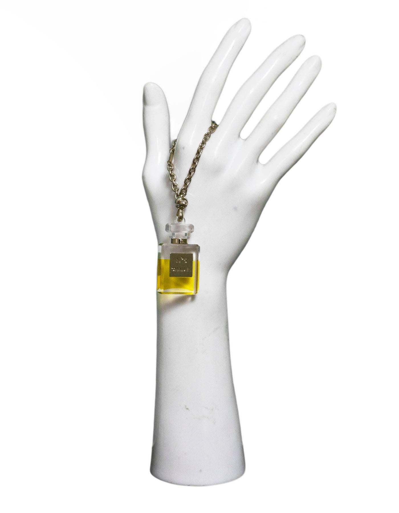 Chanel No5 Perfume Bottle Chain/Charm

Made In: Italy
Year Of Production: 2005
Color: Clear, yellow, gold
Materials: Resin, metal
Closure: Ball closure
Stamp: Chanel No5
Overall Condition: Excellent pre-owned condition, light surface marks
Included: