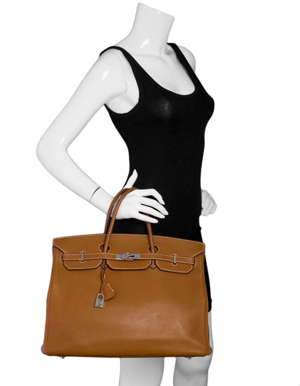 Hermes Gold Tan Clemence Leather 40cm Birkin Bag
Features white contrast stitching

Made In: France
Year of Production: 2006
Color: Gold tan
Hardware: Palladium
Materials: Clemence leather
Lining: Dark tan eather
Closure/Opening: Flap top with two
