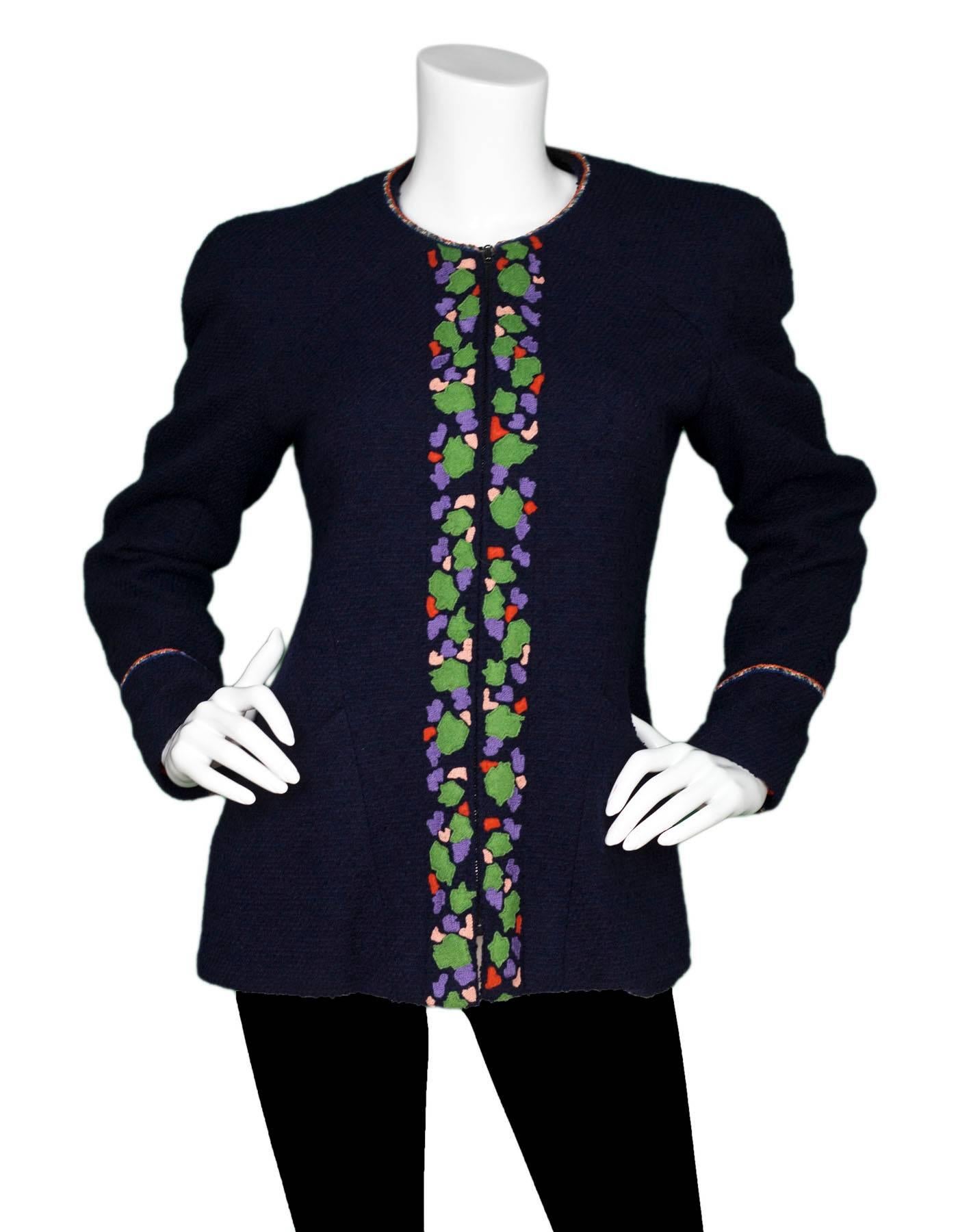 Chanel Navy Wool Boucle Jacket Sz FR40
Features green, purple and orange abstract trim and shoulder padding

Made In: France
Year of Production: 1997
Color: Navy, green, purple and orange
Composition: 88% Wool, 12% Nylon
Lining: Orange / 95% silk,