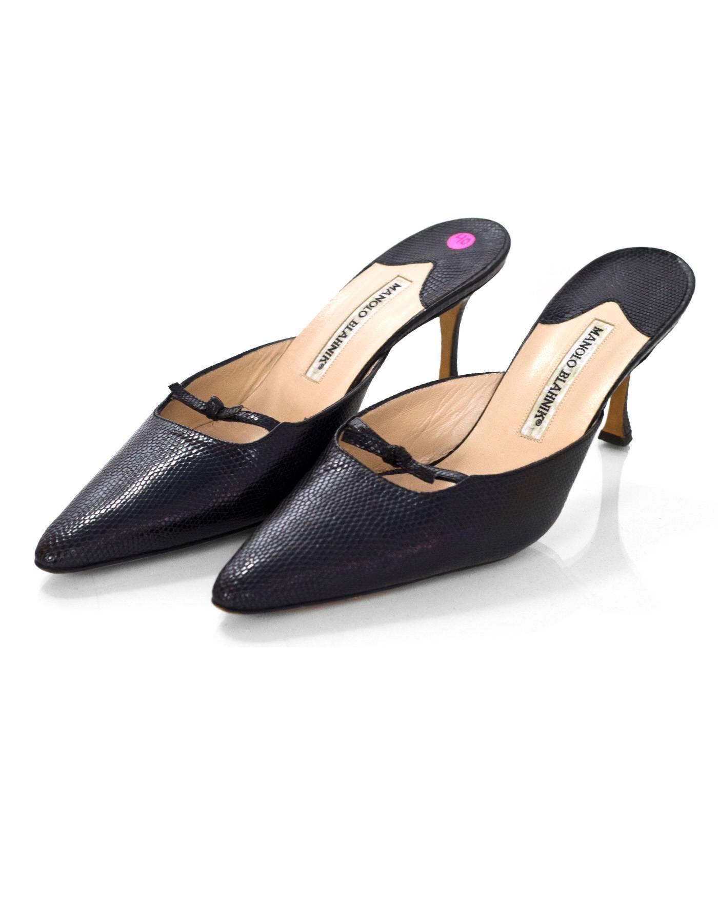 Manolo Blahnik Black Lizard Mules Sz 40

Made In: Italy
Color: Black
Materials: Lizard
Closure/Opening: Slide on
Sole Stamp: Manolo Blahnik mad3 in italy 40
Overall Condition: Excellent pre-owned condition with the exception of light wear at insoles