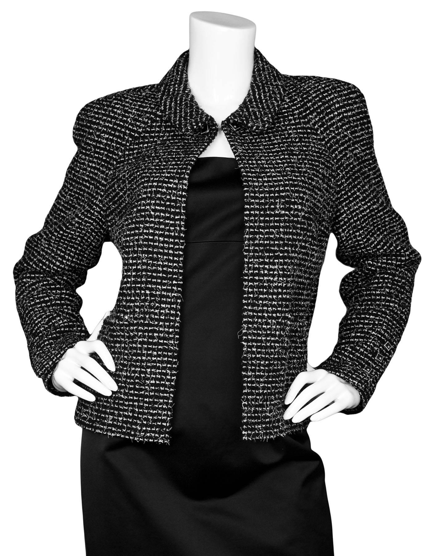 Chanel Wool Black & White Tweed Jacket Sz FR44

Made In: France
Year of Production: 2003
Color: Black, white
Composition: 70% wool, 30% nylon
Lining: Black textile
Closure/Opening: Open front with single button closure at neck
Overall Condition: