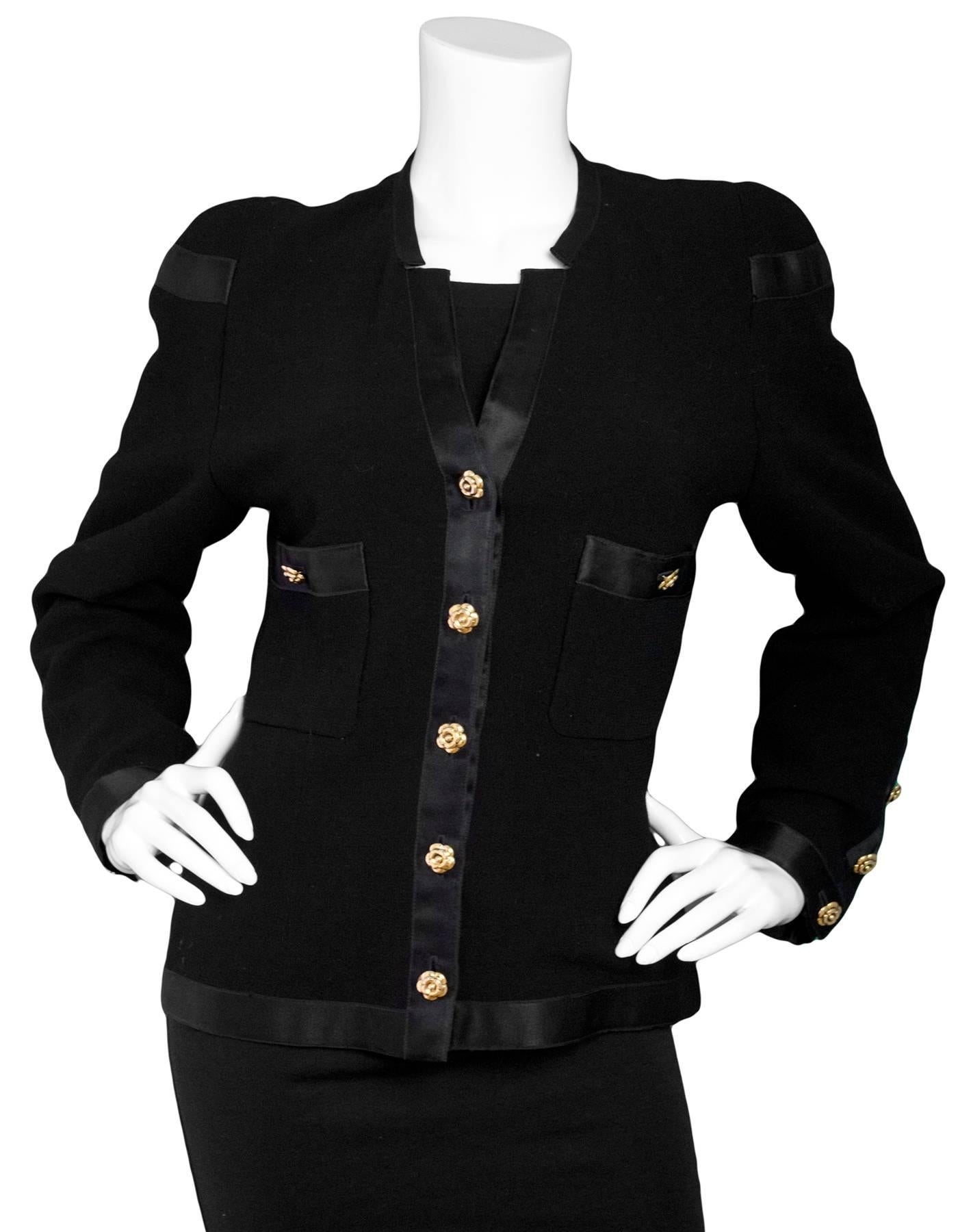 Chanel Vintage Black Boucle Jacket
Features camelia buttons and satin trim throughout

Made In: France
Color: Black
Composition: 100% Wool
Lining: Black, 100% silk
Closure/Opening: Button down front
Exterior Pockets: Two breast patch