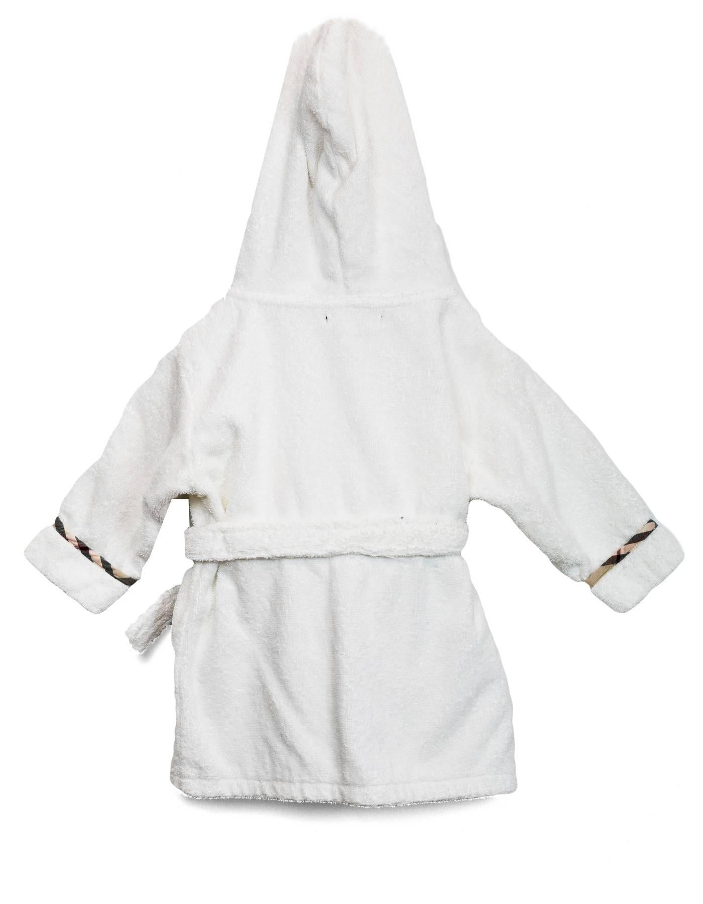 Burberry London White Terrycloth Hooded Children's Robe 
Features nova plaid piping and trim throughout

Color: White, nude, black and red
Composition: Not given- believed to be 100% cotton
Lining: White, believed to be 100% cotton
Closure/Opening: