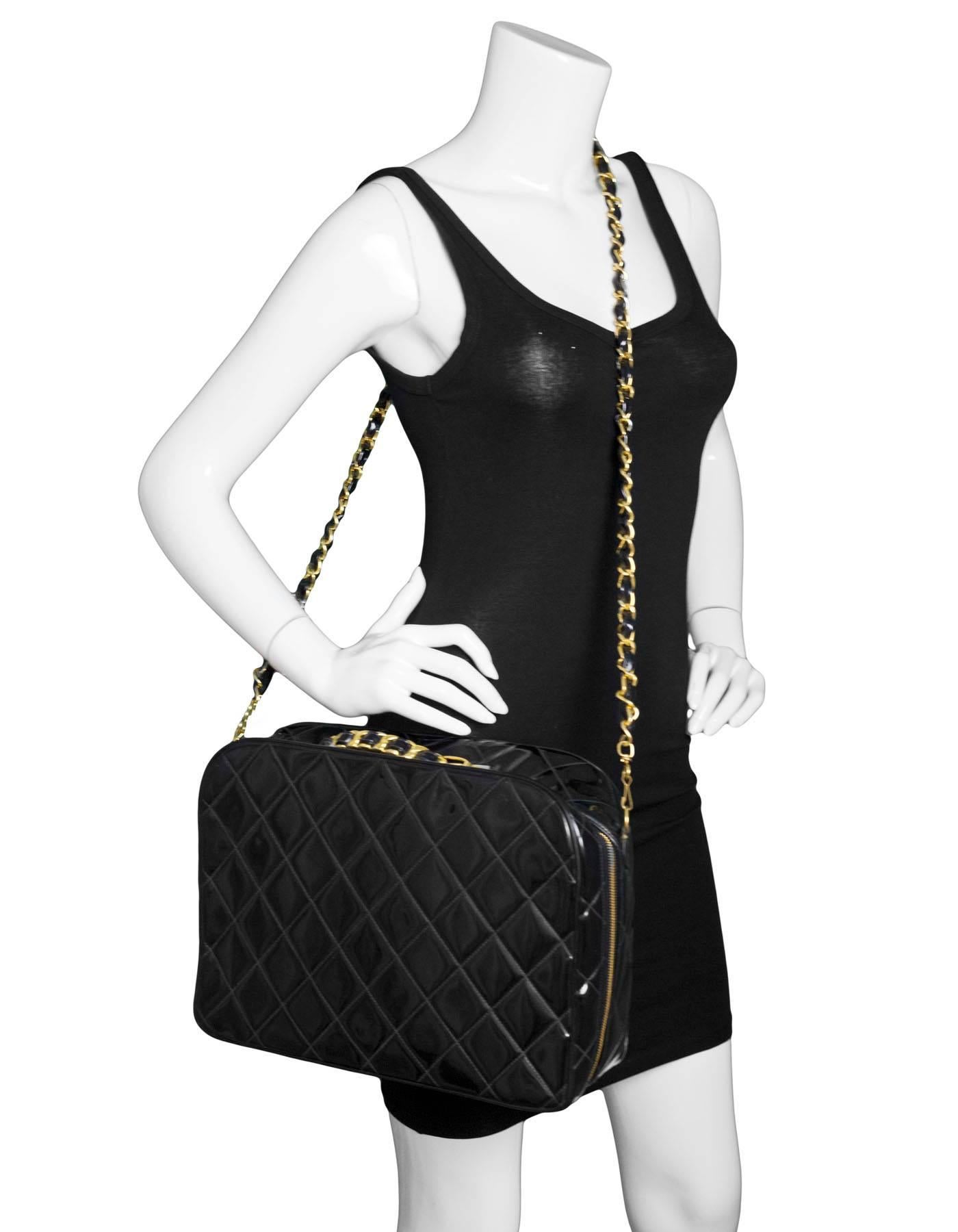 Chanel Vintage Black Quilted Patent Travel Bag 
Features optional patent leather woven goldtone crossbody strap

Made In: France
Year of Production: 1994-1996
Color: Black
Hardware: Goldtone
Materials: Patent leather
Lining: Black