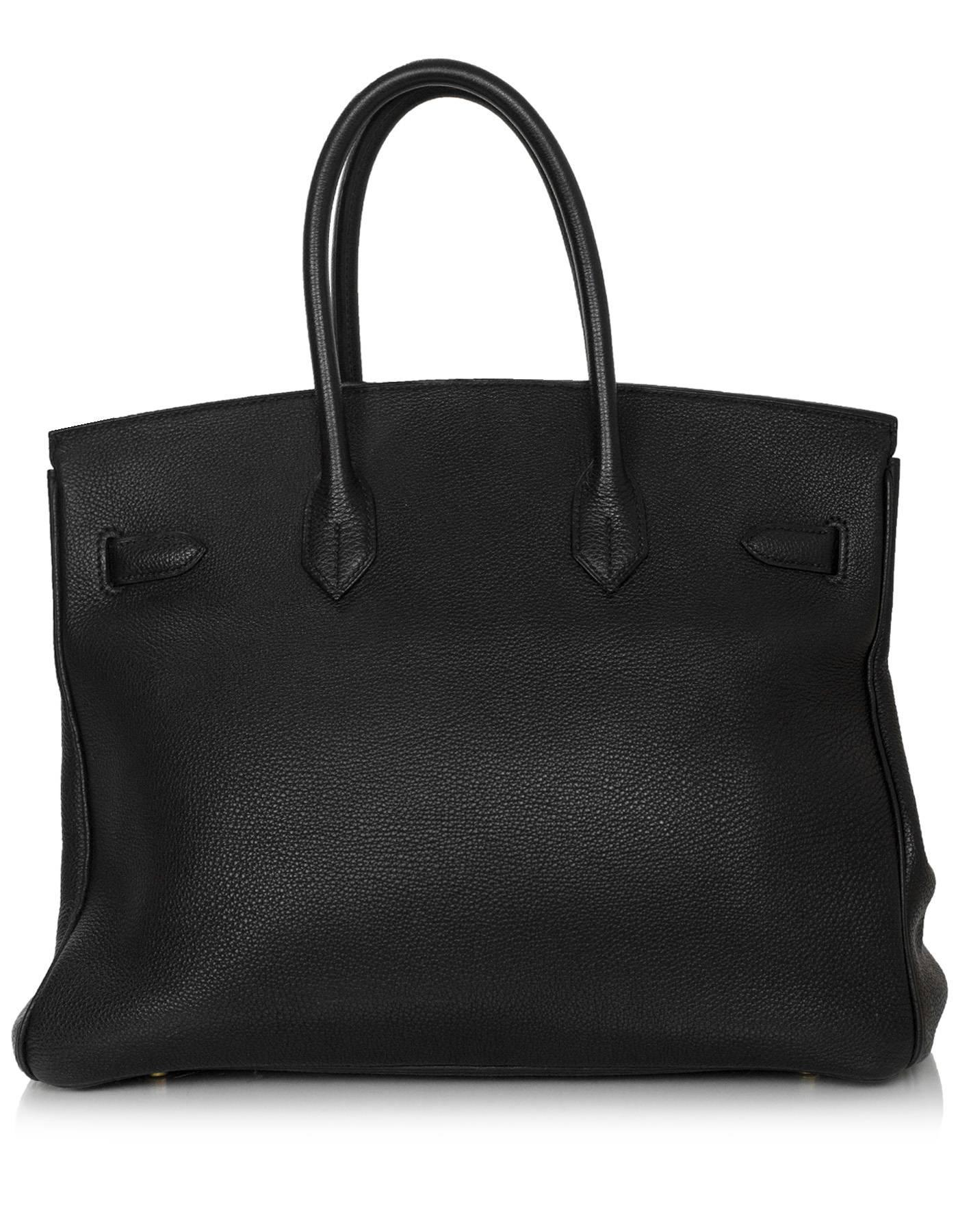 Hermes Black Togo 35cm Birkin Bag

Made In: France
Year of Production: 2003
Color: Black
Hardware: Goldtone
Materials: Togo leather
Lining: Black chevre leather
Closure/Opening: Flap top with two leather arms that come to center for twist
