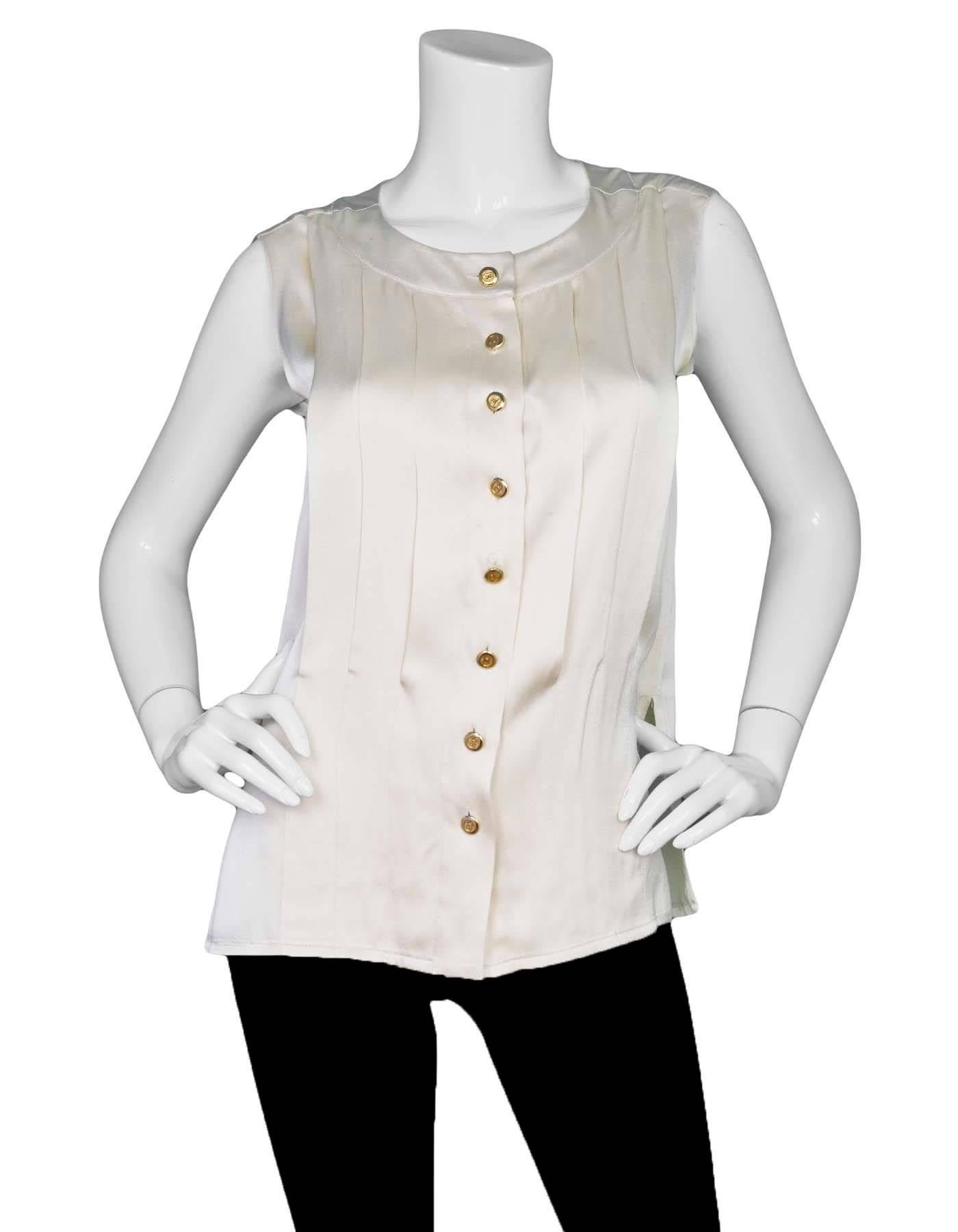 Chanel Cream Silk Pleated Button Down Top

Color: Cream
Composition: Not given-believed to be 100% silk
Lining: None
Closure/Opening: Button down front
Exterior Pockets: None
Interior Pockets: None
Overall Condition: Good vintage, pre-owned