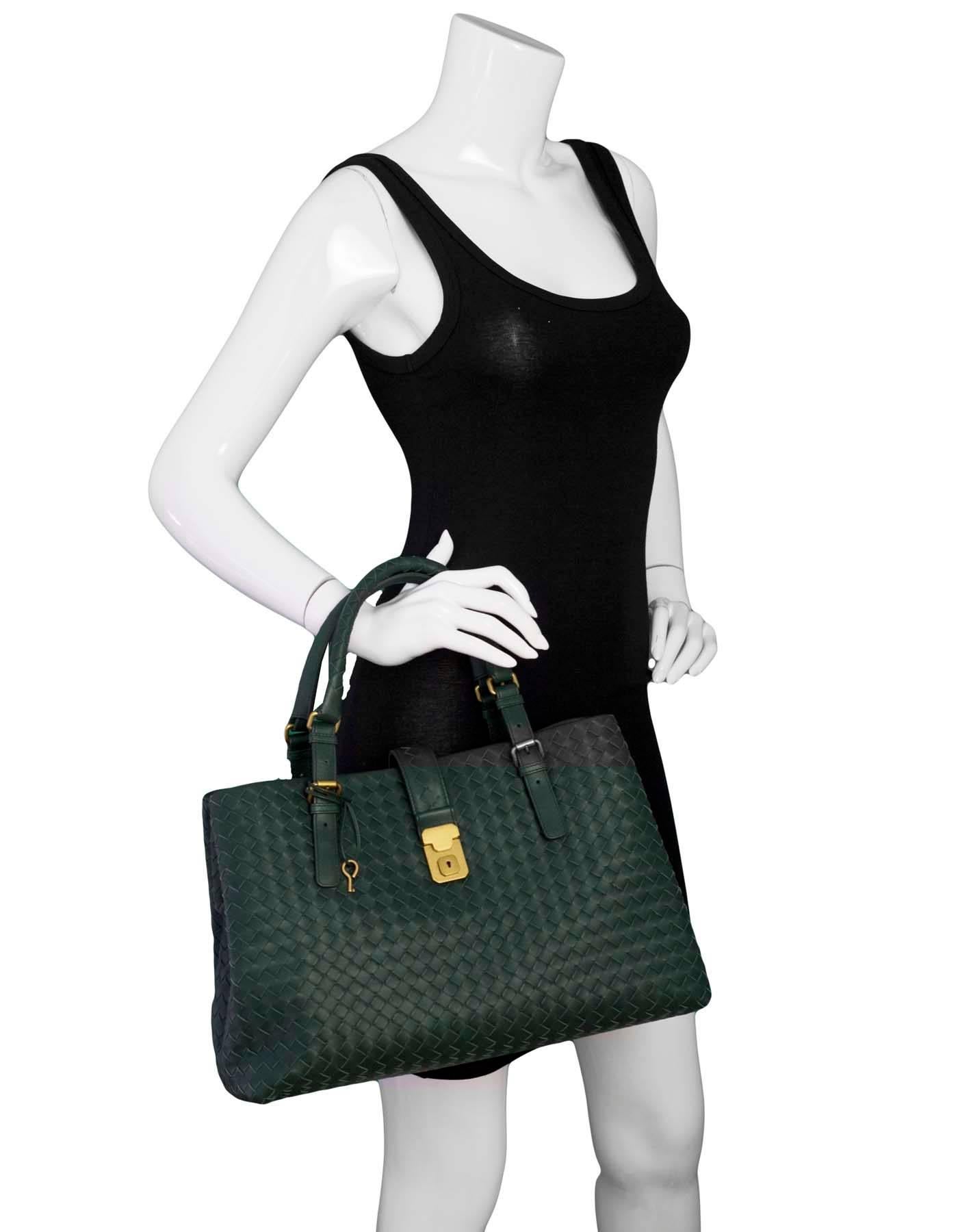 Bottega Veneta Green Intrecciato Roma Tote

Made In: Italy
Color: Green
Hardware: Goldtone
Materials: Leather, metal
Lining: Purple textile
Closure/Opening: Open top with center strap
Exterior Pockets: Three compartments
Interior Pockets: One zip