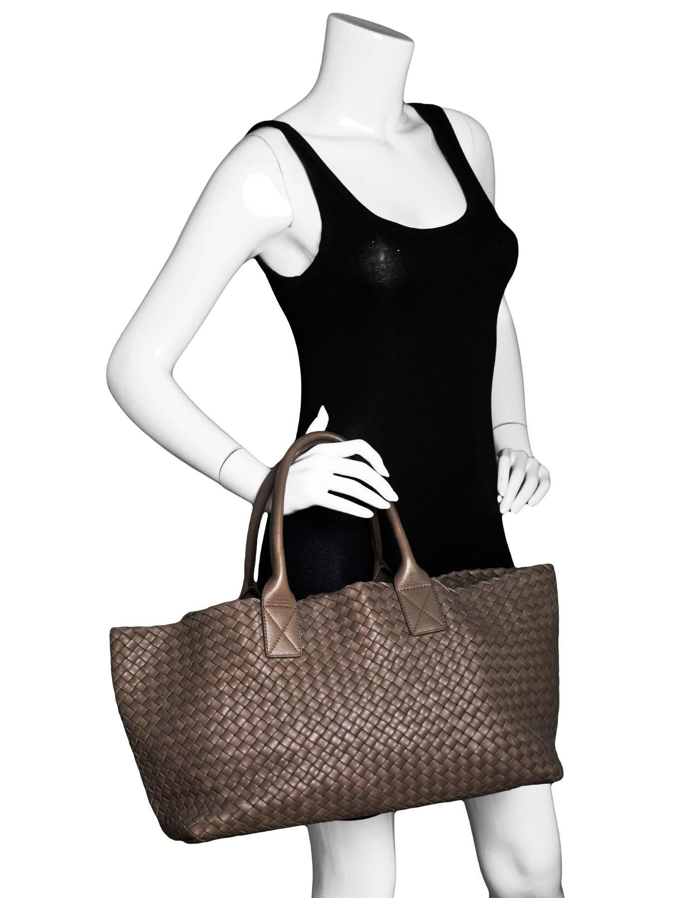 Bottega Veneta Taupe Leather Intrecciato Cabat Tote
The Cabat is one of Bottega's signature bags designed by Tomas Maier’s. This piece is handmade  woven entirely in soft nappa leather with has zero seams.

Made In: Italy
Color: Taupe
Hardware: