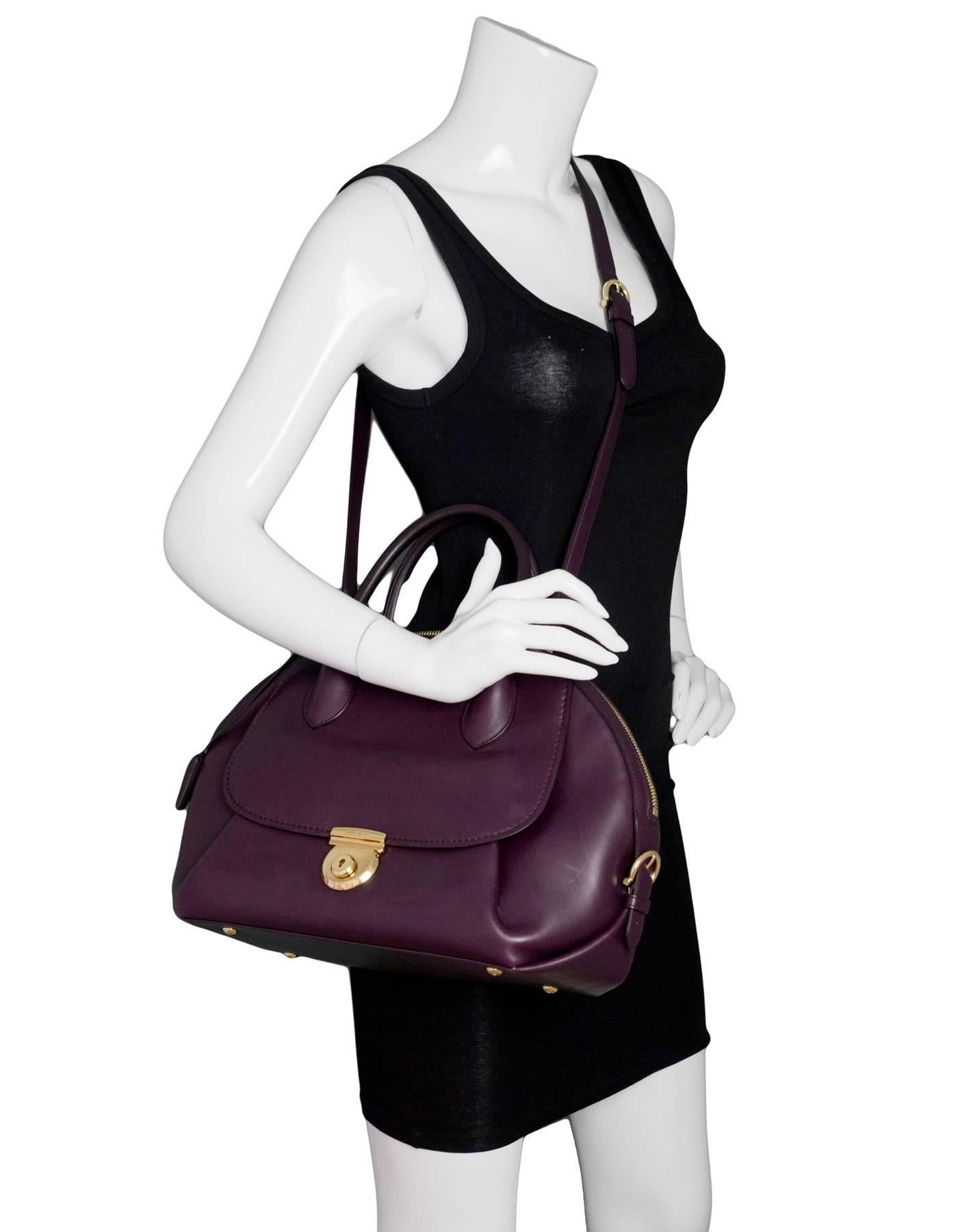 Salvatore Ferragamo Plum Leather Medium Fiamma Bowler Bag
Features optional shoulder strap

Made In: Italy
Color: Plum purple
Hardware: Goldtone
Materials: Leather, metal
Lining: Plum textile
Closure/Opening: Double zip top
Exterior Pockets: Front