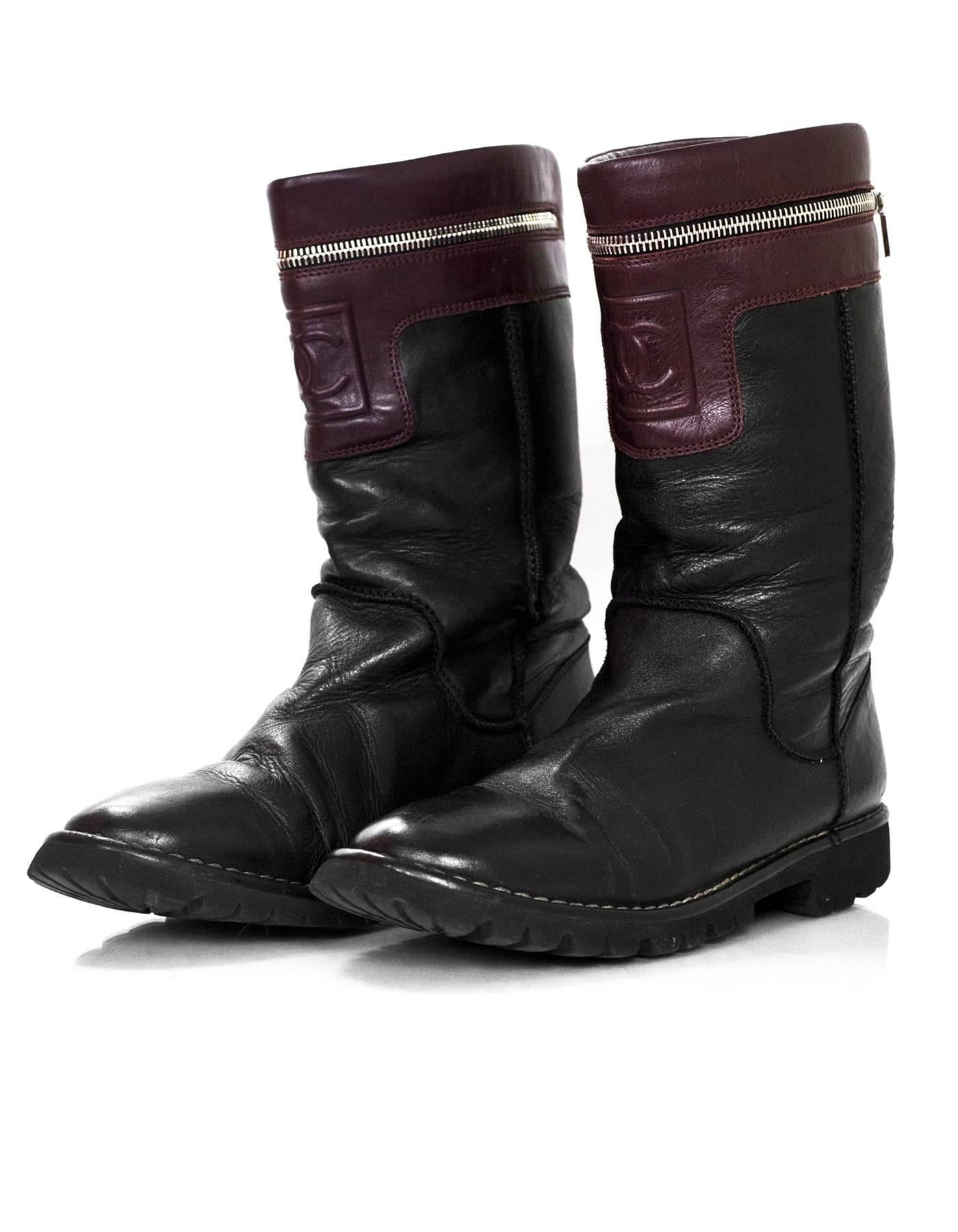 Chanel Black & Burgundy Calfskin Moto Zipper Boots Sz 40

Made In: Italy
Color: Black, burgundy
Materials: Leather
Closure/Opening: Pull-up
Sole Stamp: Chanel Made in Italy
Retail Price: $1,195 + tax
Overall Condition: Very good pre-owned condition