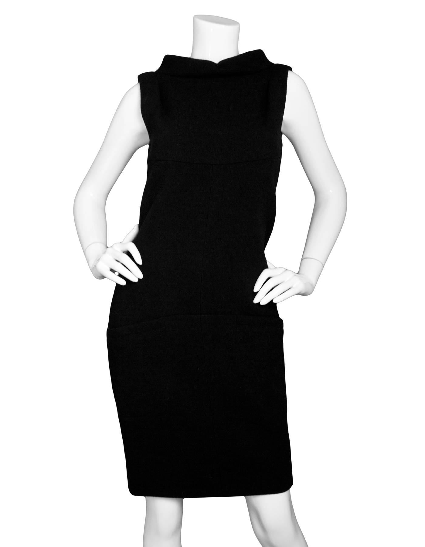 Chanel Black Wool Sleeveless Cowl-Neck Dress Sz FR38

Made In: France
Color: Black
Composition: 99% Wool, 1% Spndex
Lining: Black silk
Closure/Opening: Zip closure at back with keyhole detail and decorative button at neck
Exterior Pockets: Two slit