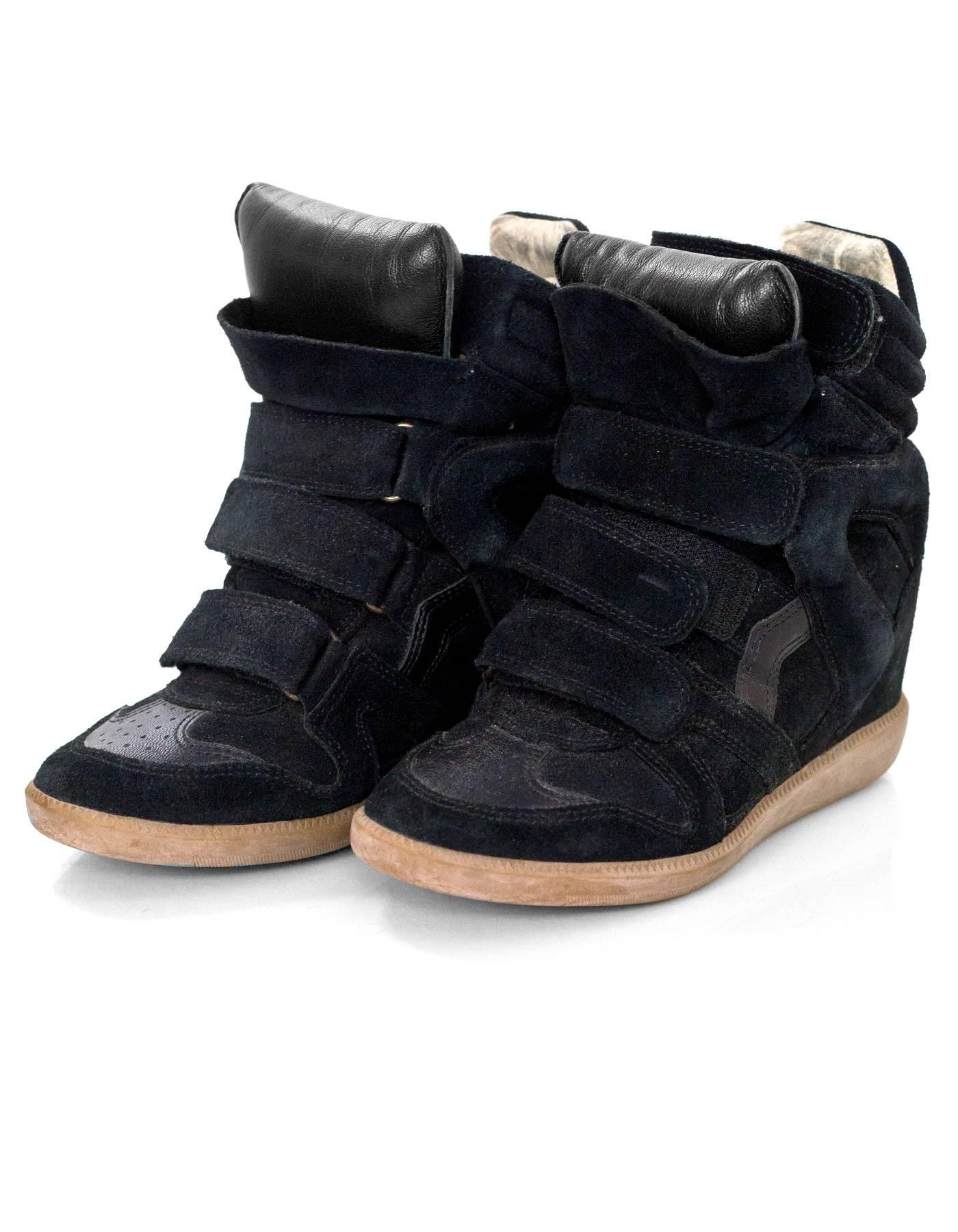 Isabel Marant Black Beckett Suede Wedge Sneakers Sz 36

Made In: Portugal
Color: Black
Materials: Suede, leather
Closure/Opening: Velcro closures
Sole Stamp: Isabel Marant 36
Overall Condition: Very good pre-owned condition with the exception of