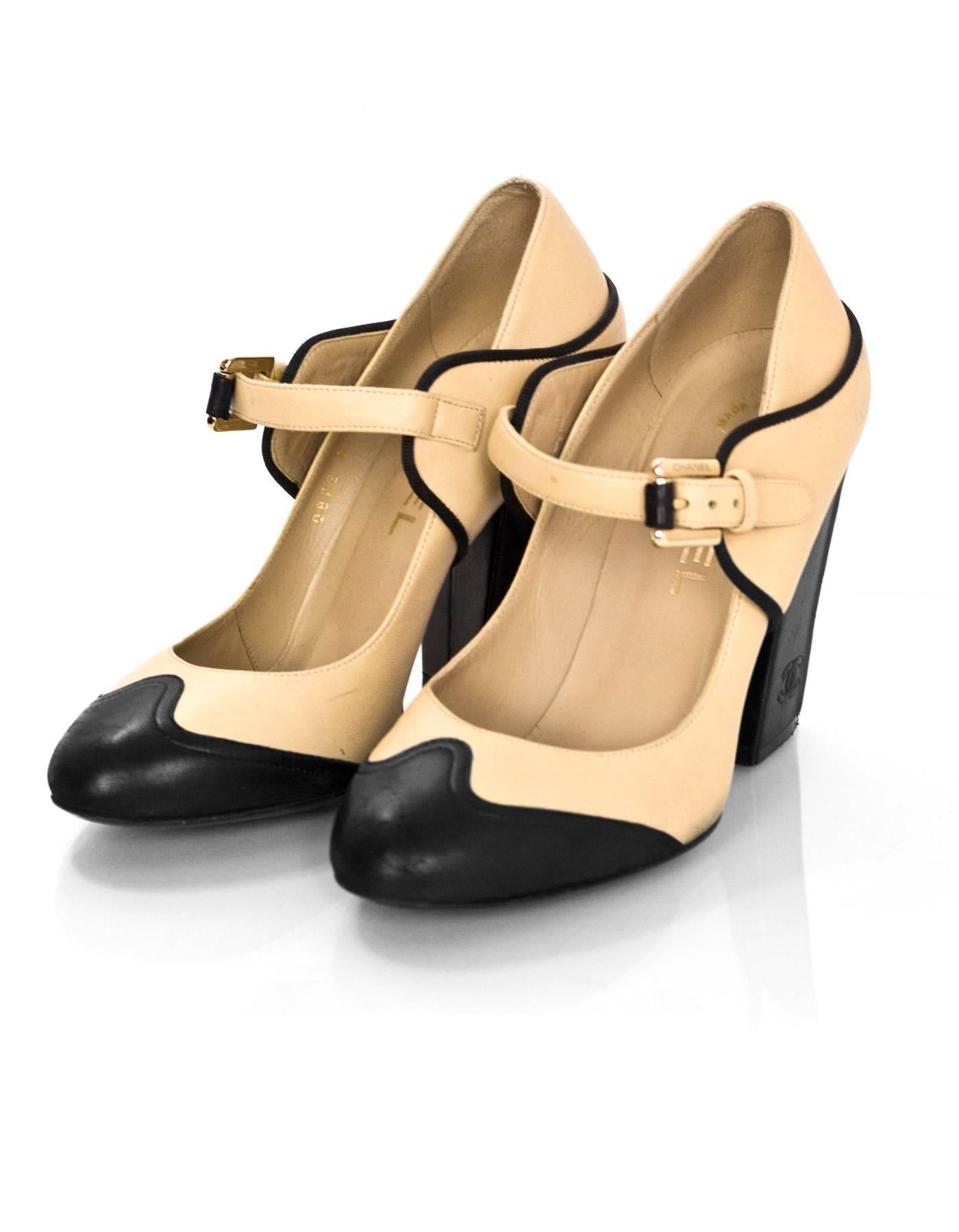 Chanel Beige & Black Leather Mary Jane Pumps Sz 36

Made In: Italy
Color: Beige, black
Materials: Leather
Closure/Opening: Buckle closure across vamp
Sole Stamp: CC Made in Italy 36
Overall Condition: Excellent pre-owned condition with the exception