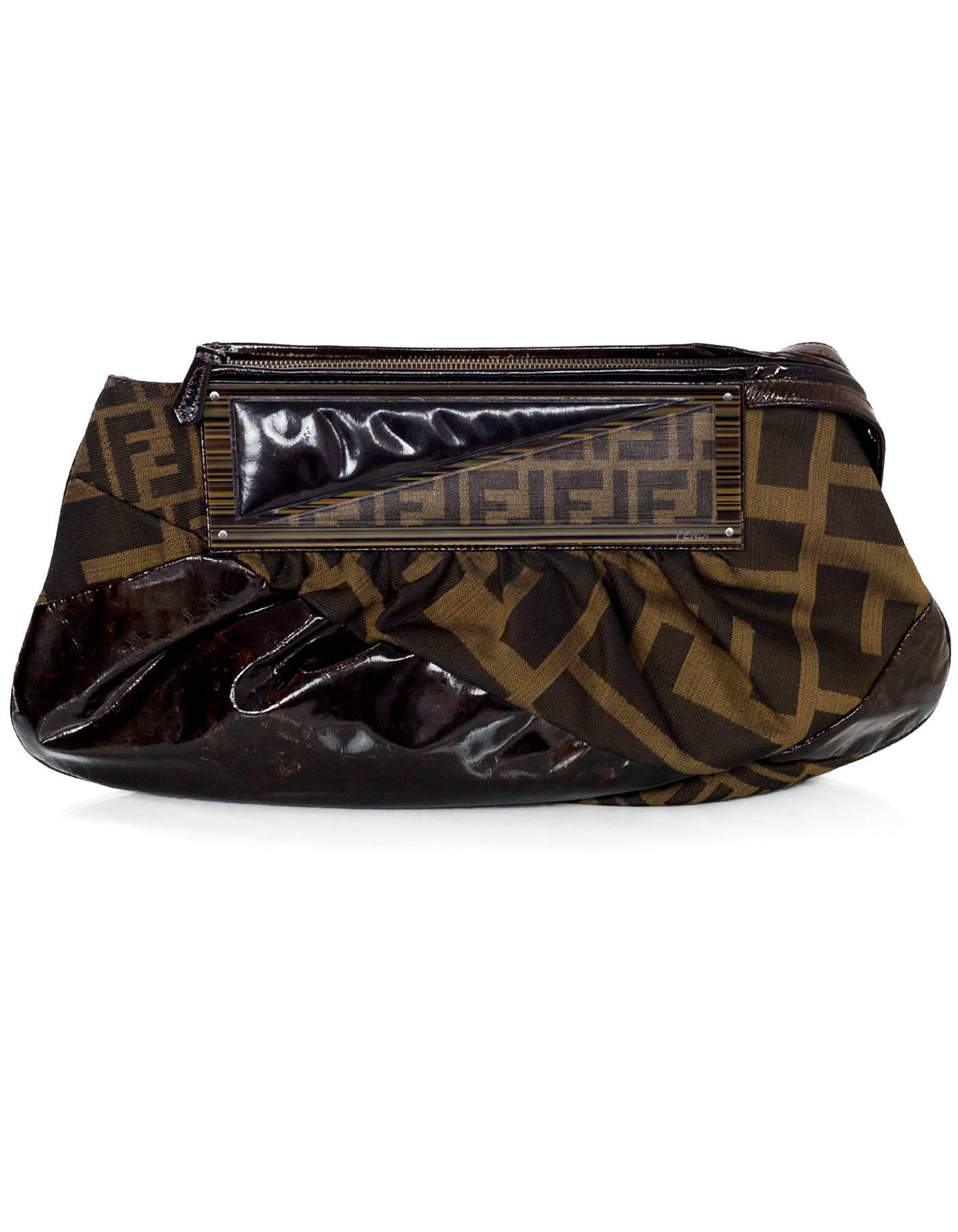 Fendi Brown Borsa Pochette Macrozuc/Tobacco Bag

Made In: Italy
Color: Brown
Hardware: Brass
Materials: Coated canvas, canvas, patent leather
Lining: Black textile
Closure/Opening: Zip top
Exterior Pockets: None
Interior Pockets: Zip wall