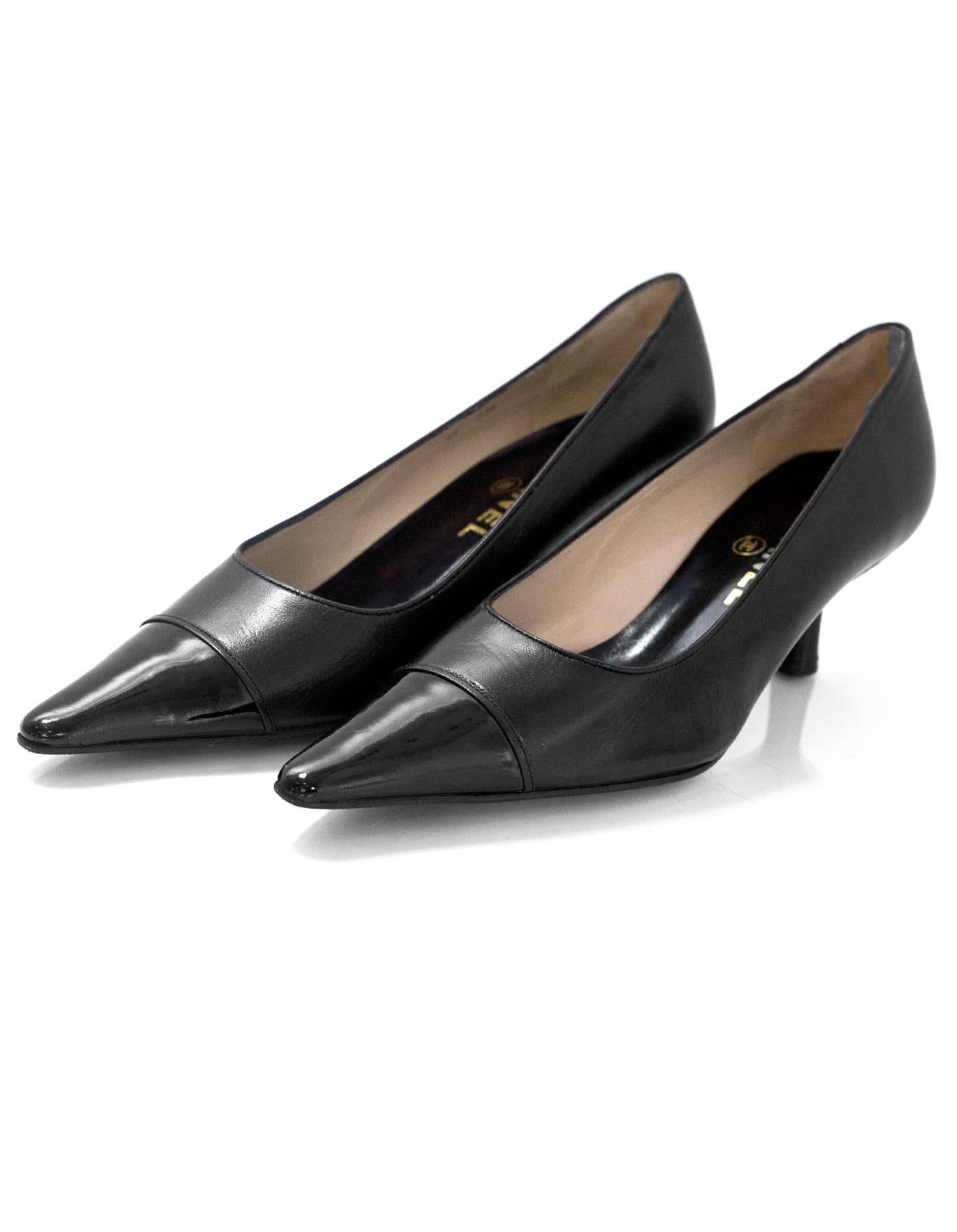 Chanel Black Leather Pointed Toe Kitten Heels 
Features patent toe cap

Made In: France
Color: Black
Materials: Leather and patent leather
Closure/Opening: Slip on
Sole Stamp: CC Made in France 38
Overall Condition: Excellent pre-owned condition