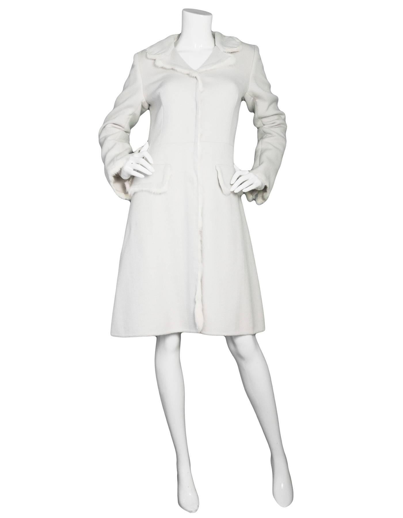 Prada Off-White Cashmere & Fur Coat
Features off-white fur trim throughout

Made In: Italy
Color: Off-white
Composition: 52% wool, 48% angora
Lining: None
Closure/Opening: Button down front
Exterior Pockets: Two hip flap pockets
Interior Pockets: