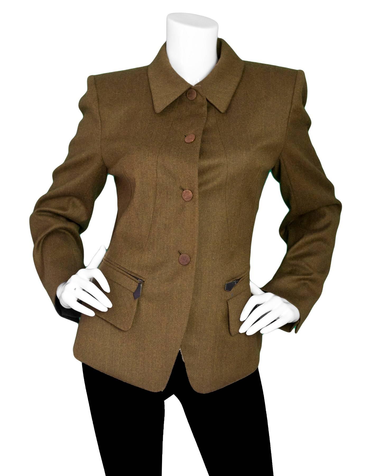 Hermes Vintage Olive Green Wool Riding Jacket

Made In: France
Color: Olive green
Composition: 90% wool, 10% cashmere
Lining: Burgundy stripe, 100% acetate
Closure/Opening: Button down front
Exterior Pockets: Two zipper pockets and two flap