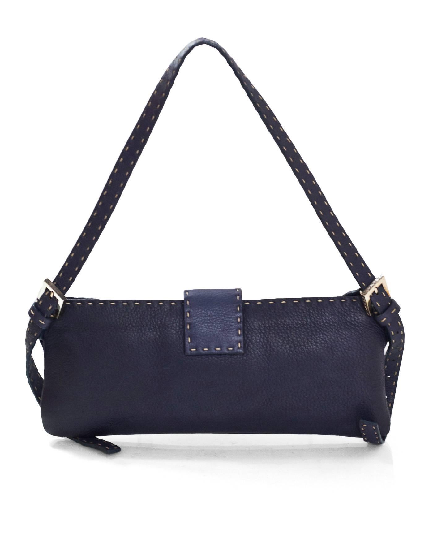 Fendi Navy Leather Selleria Bag

Features contrast stitching

Made In: Italy
Colors: Navy
Hardware: Silvertone 
Materials: Leather, metal
Lining: Beige textile
Closure/Opening: Zip top closure with center snap flap
Exterior Pockets: None
Interior