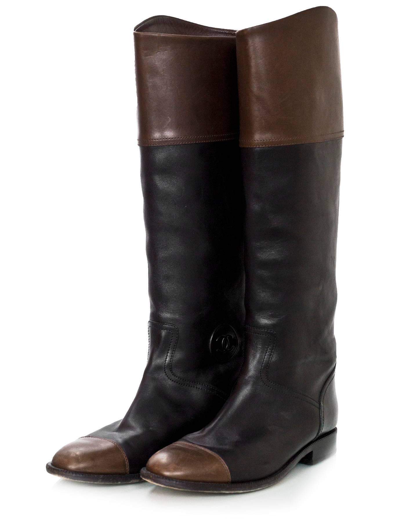Chanel Black & Brown Leather Cap-Toe Riding Boots Sz 41

Made In: Italy
Color: Black, brown
Materials: Leather
Closure/Opening: Pull-up
Sole Stamp: CC Made in Italy 41
Overall Condition: Excellent pre-owned condition with the exception of some