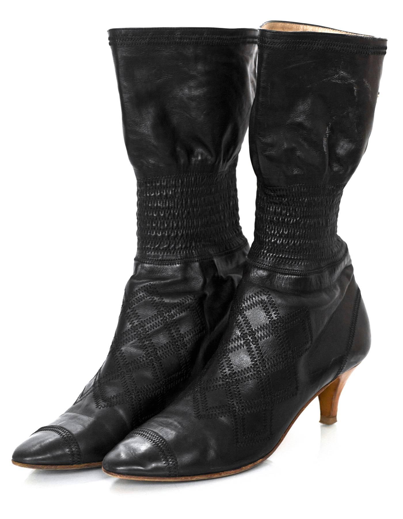Chanel Black Quilted Stretch Boots Sz 40

Color: Black
Materials: Leather
Closure/Opening: Pull-up
Sole Stamp: CC 40
Overall Condition: Good pre-owned condition with the exception of wear and scuffing at heels, wear at outsoles, scuffing at