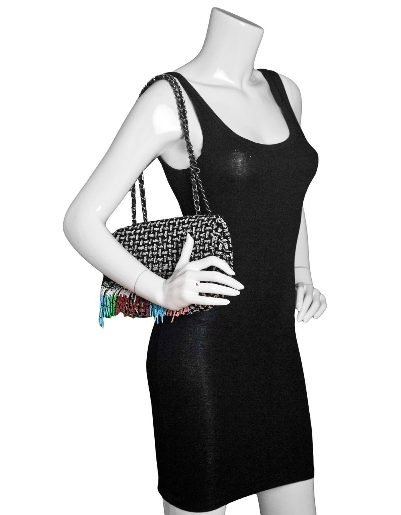 Chanel Black & White Tweed Paris/Dallas Beaded Flap Bag
Features adjustable shoulder strap

Made in: Italy
Year of Production: 2014
Color: Black, white, multi
Hardware: Gunmetal
Materials: Tweed, leather, metal, beads
Lining: Black