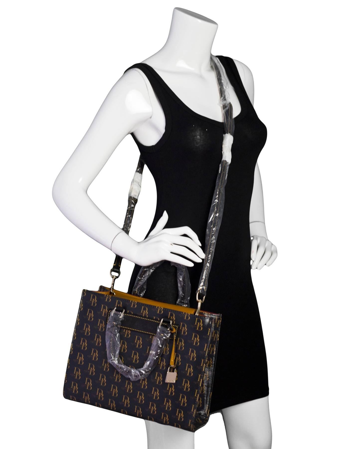 Dooney & Bourke Black Monogram Medium Janine Satchel NWT

Color: Black, tan
Hardware: Goldtone
Materials: Coated canvas, leather, metal
Lining: Red textile
Closure/Opening: Open top with center flap and snap
Exterior Pockets: None
Interior Pockets: