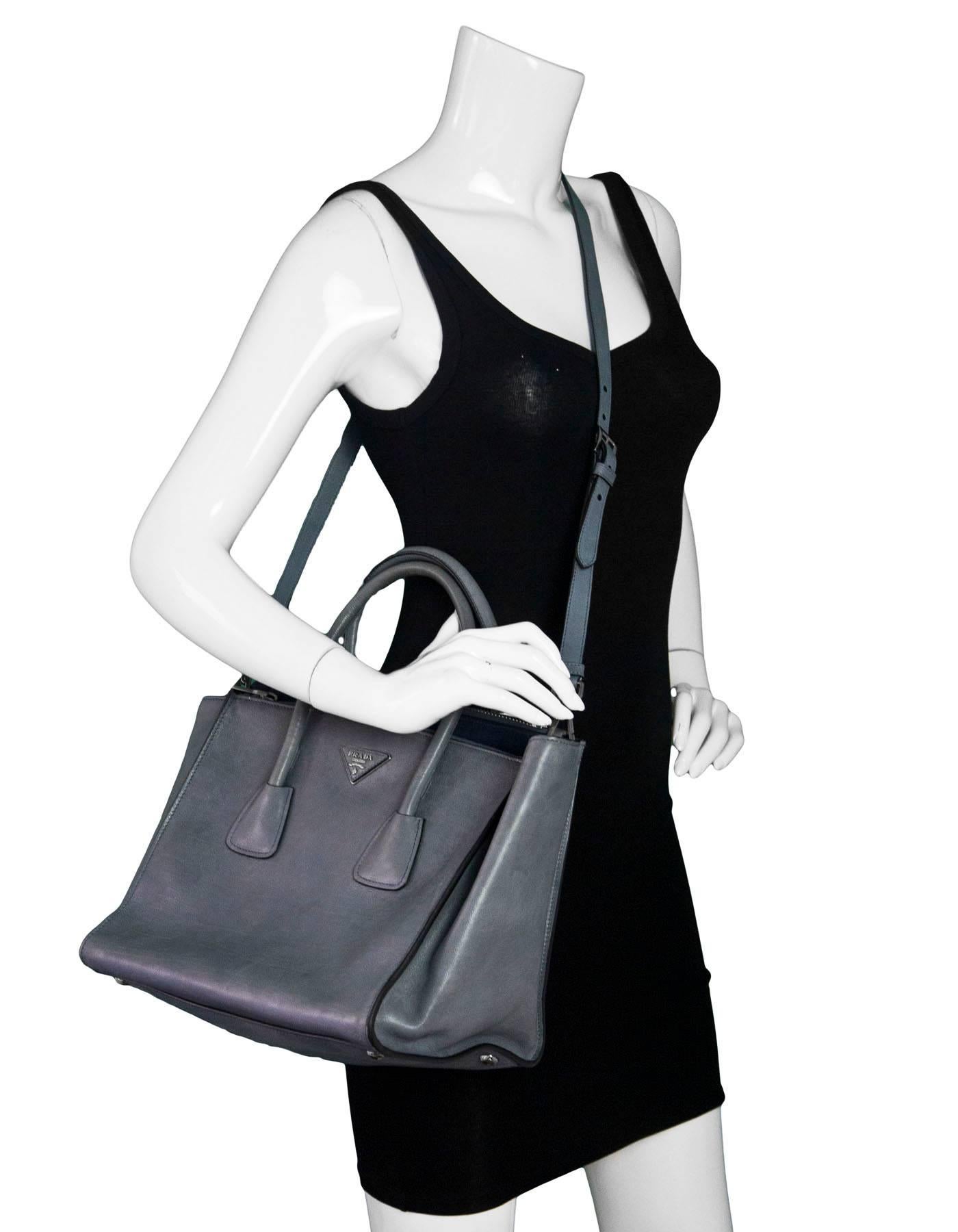 Prada Marine Blue Glace Calf Leather Twin Pocket Tote

Made In: Italy
Color: Blue
Materials: Calfskin leather
Lining: Blue suede
Closure/Opening: Open top with center snap
Exterior Pockets: Zip pocket compartments at front and back
Interior Pockets: