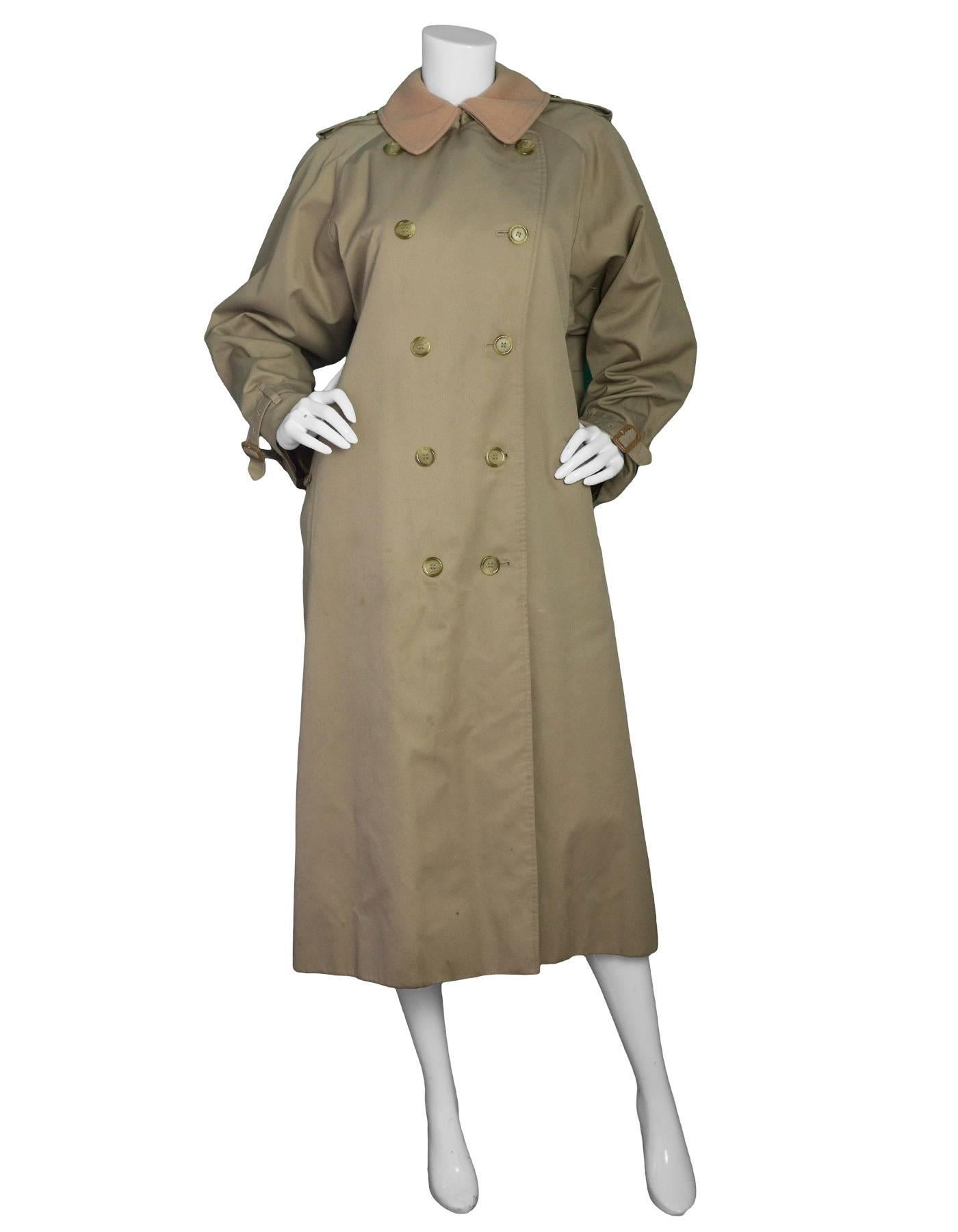Burberry London Tan Trench Coat 
Features detachable zip around wool lining and collar

Color: Tan
Lining: 100% wool
Closure/Opening: Button down front
Exterior Pockets: Two hip pockets
Interior Pockets: None
Overall Condition: Very good pre-owned