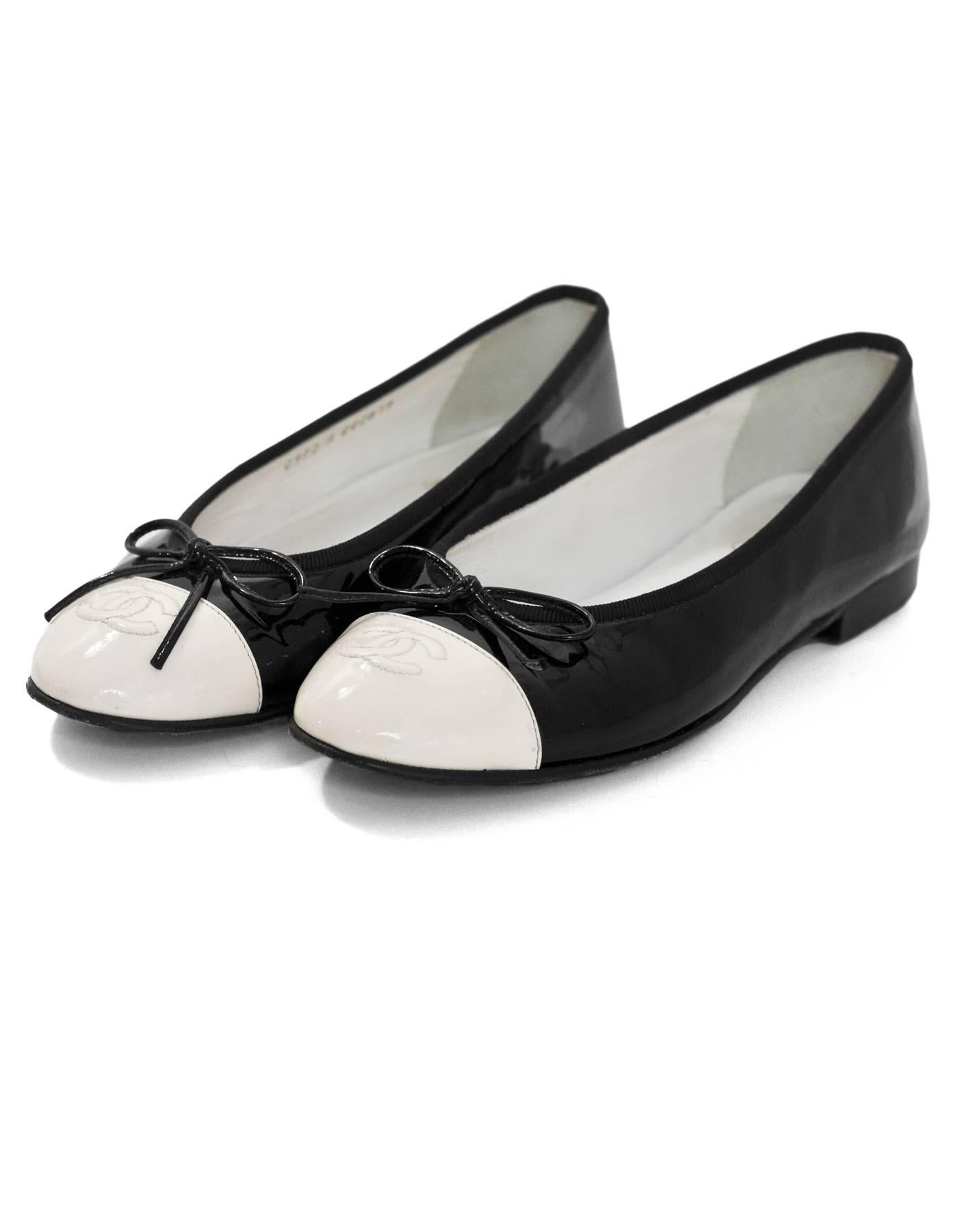 Chanel Black & White Patent Cap-Toe Flats Sz 37

Made In: Italy
Color: Black, white
Materials: Patent leather
Closure/Opening: Slide on
Sole Stamp: CC made in italy 37
Overall Condition: Very good pre-owned condition with the exception of some wear