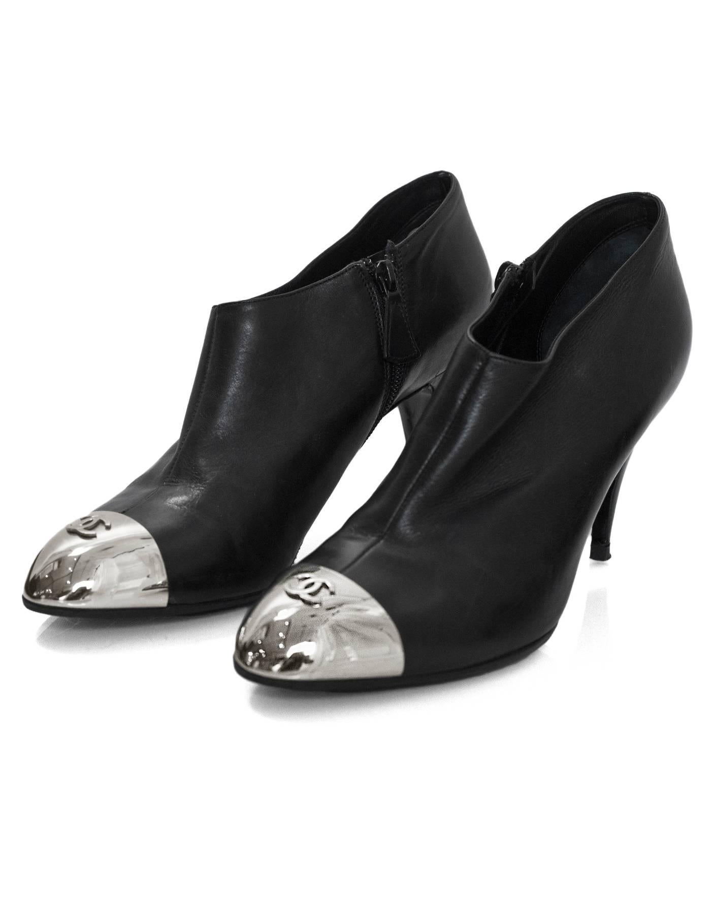 Chanel Black Leather & Silver Cap-Toe Booties Sz 40

Made In: Italy
Color: Black, silver
Materials: Leather, metal
Closure/Opening: Side zip
Sole Stamp: CC Made in Italy 40
Overall Condition: Excellent pre-owned condition with the exception of being