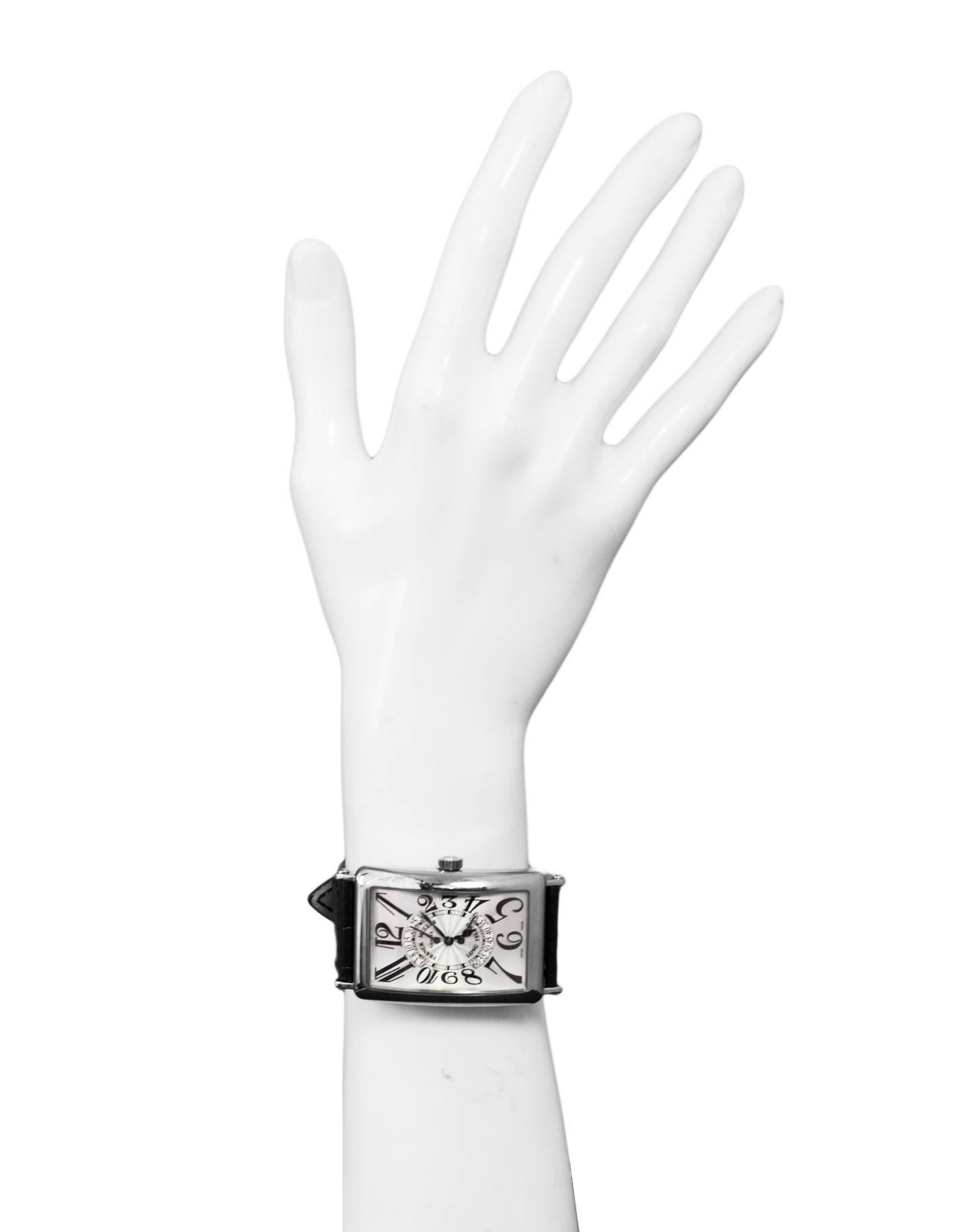 Franck Muller 18k White Gold Long Island Bi-Retrograde Automatic Watch
Features a 32mm x 55mm 18k white gold case surrounding a silvered dial on a black alligator strap with an 18k white gold buckle. Functions include hours, minutes and