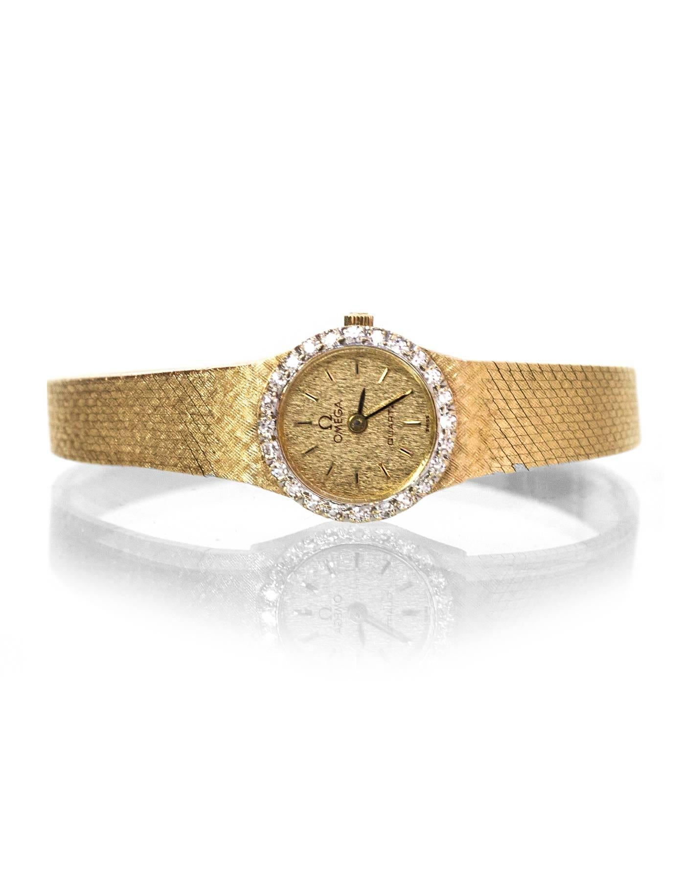 Omega Vintage Diamond & 14k Gold 15mm Watch
Features diamonds framing watch face

Made In: Switzerland
Color: Gold
Materials: 14k gold and diamond
Closure/Opening: Butterfly clasp 
Stamp: 14k GOLD 1375
Movement: Quartz
Overall Condition: Excellent