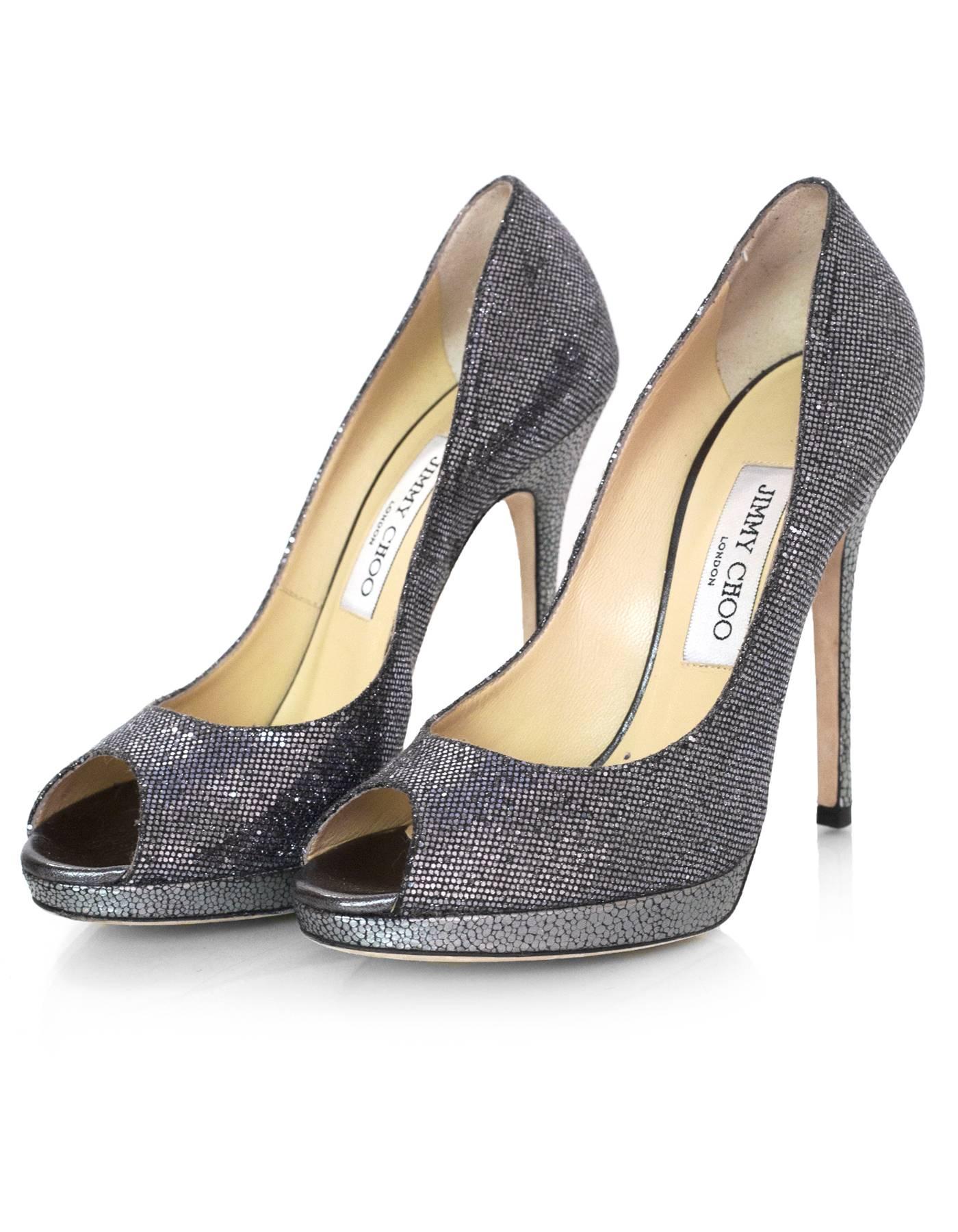 Jimmy Choo Silver Glitter Platform Peep Toe Pumps sz 37.5

Made In: Italy
Color: Silver
Materials: Glitter mesh
Closure/Opening: Slip on
Sole Stamp: Jimmy Choo London Made in Italy 37 1/2
Overall Condition: Excellent pre-owned condition with the