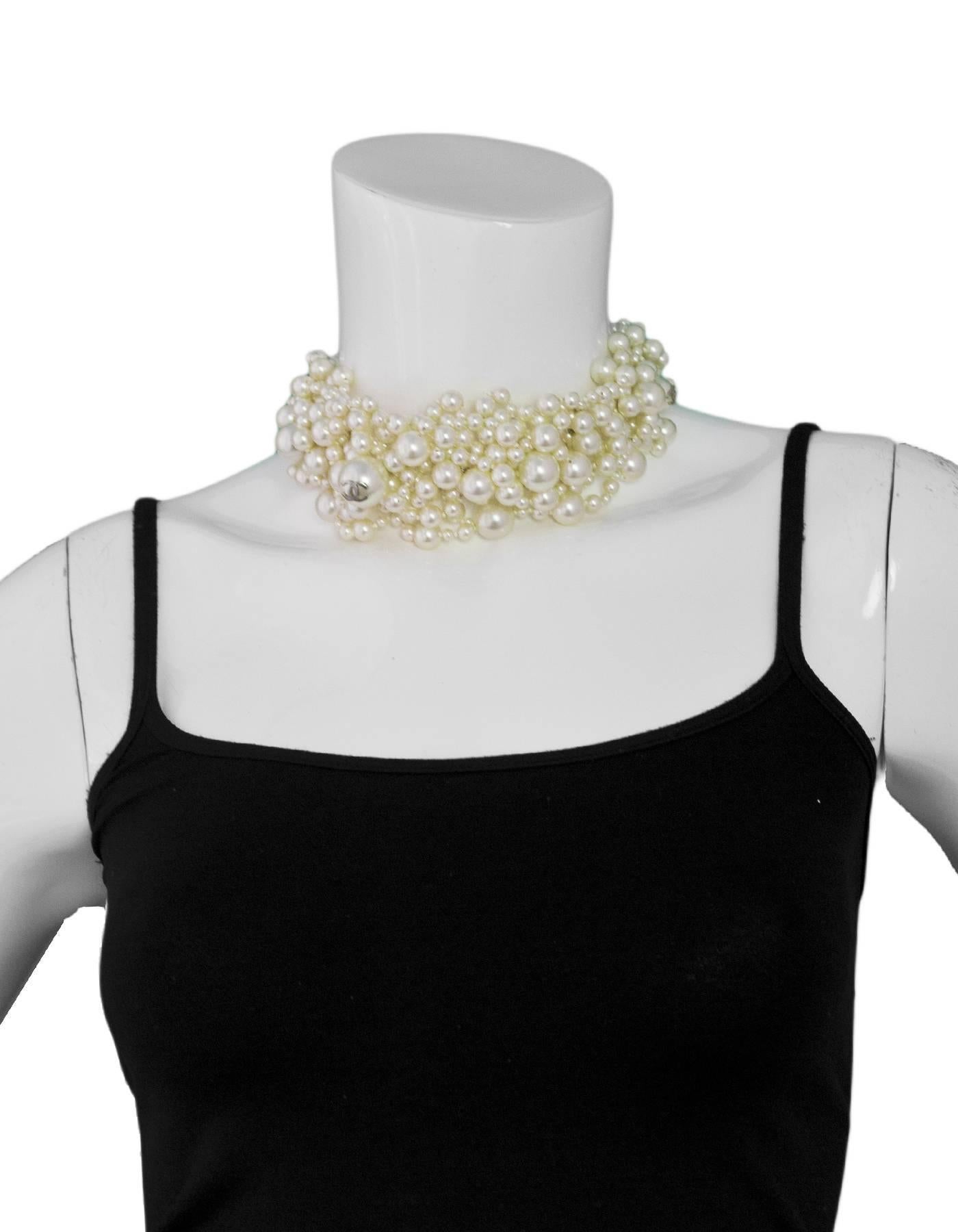 Chanel Ivory Faux Pearl Bubble Choker Necklace

Made In: France
Year of Production: 2013
Color: Ivory and silvertone
Materials: Metal, faux pearl
Closure: Lobster claw closure
Stamp: Chanel 13CCS Made in France
Overall Condition: Excellent pre-owned
