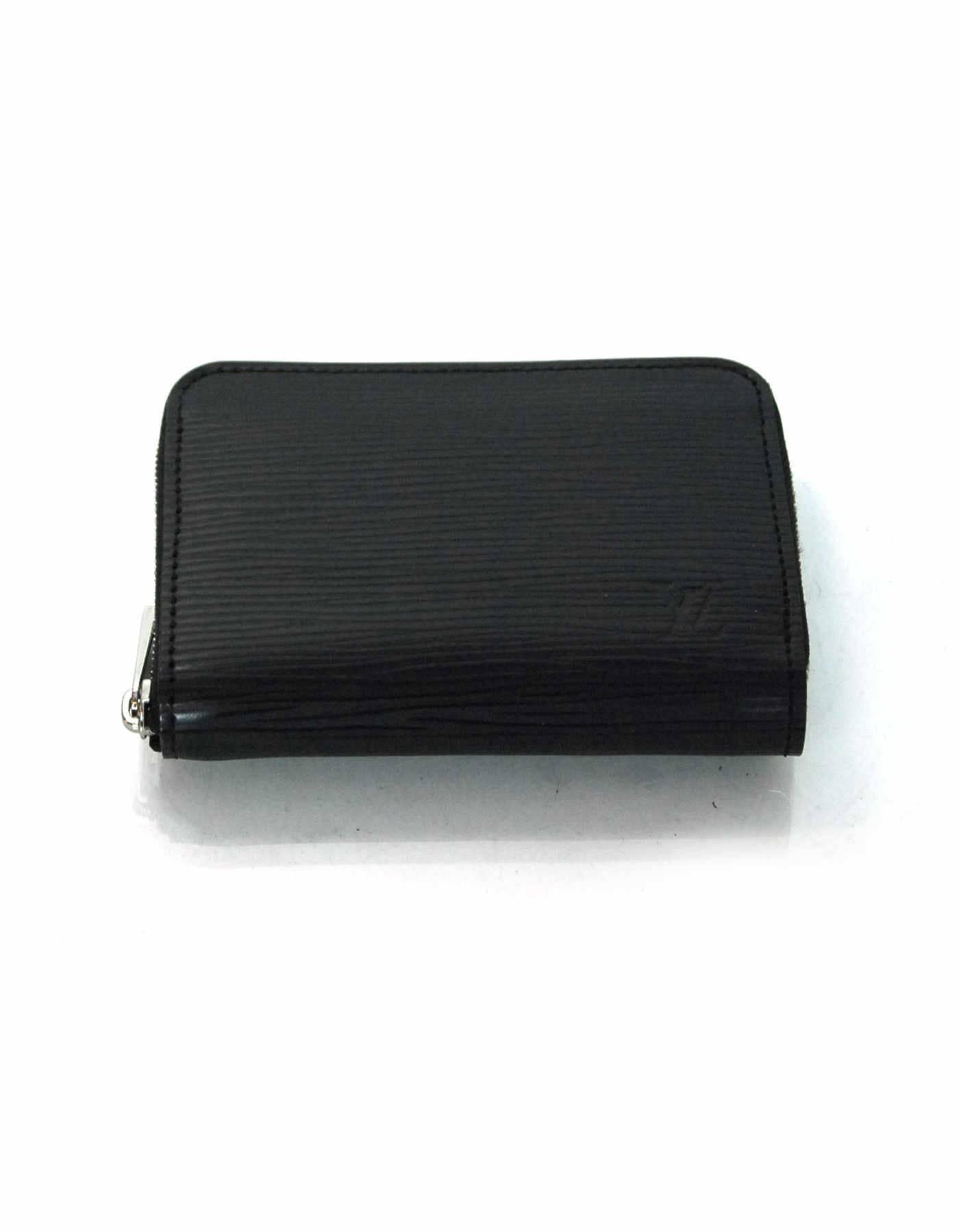 Louis Vuitton Black Epi Zippy Coin Purse

Made In: France
Color: Black
Hardware: Silvertone
Materials: Epi leather, metal
Lining: Black leather
Serial Number/Date Code: TH4019
Closure/Opening: Zip around closure
Exterior Pockets: None
Interior