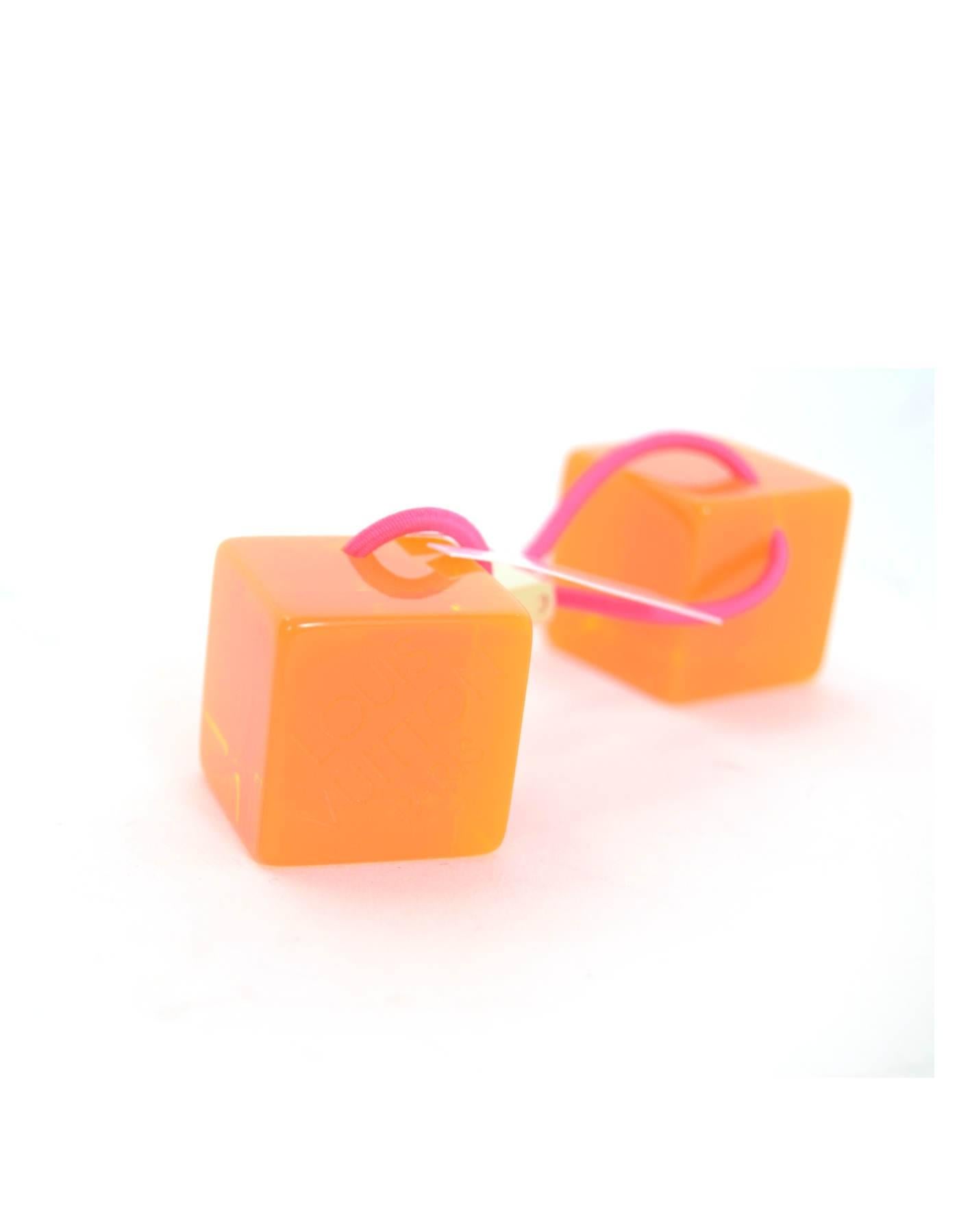 Louis Vuitton Orange Lucite Hair Cubes NIB

Made In: Italy
Color: Orange
Hardware: Goldtone
Materials: Lucite, brass, elasticized band
Retail Price: $295 + tax
Overall Condition: Excellent pre-owned condition - NIB
Included: Louis Vuitton