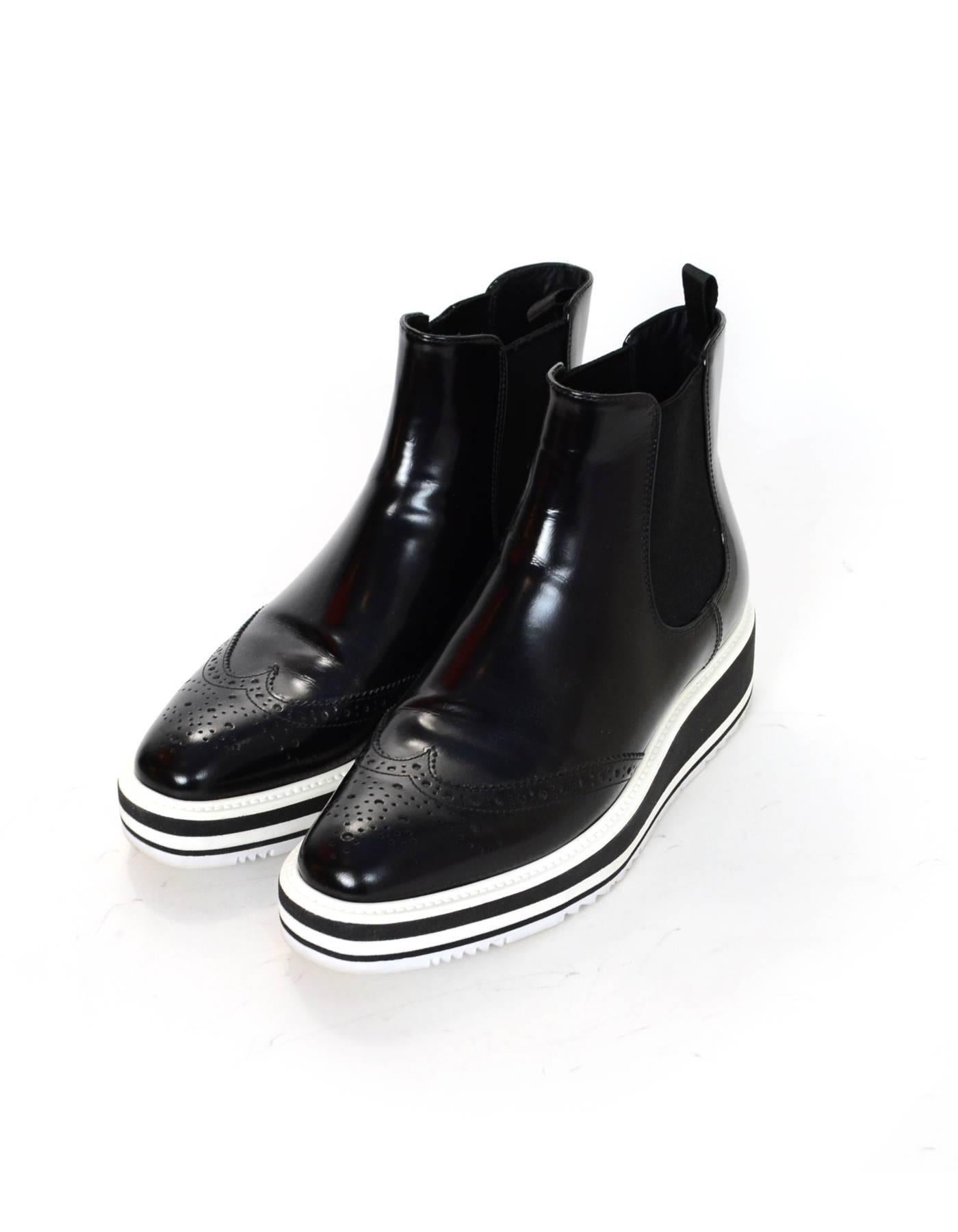 Prada Black Leather Micro-Sole Wing-Tip Chelsea Ankle Boots Sz 37

Made In: Italy
Color: Black
Materials: Leather
Closure/Opening: Slip on with stretch sides
Sole Stamp: Prada 37
Retail Price: $990 + tax
Overall Condition: Excellent pre-owned