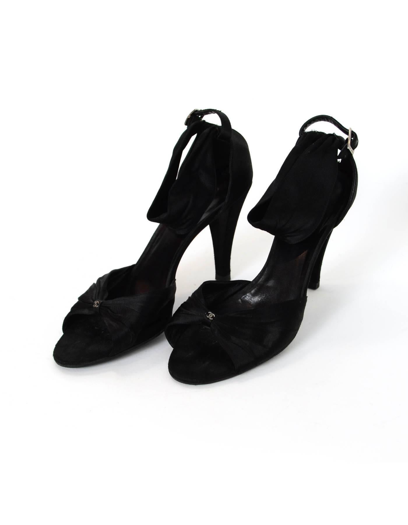 Chanel Black Satin Sandals Sz 41

Made In: Italy
Color: Black
Materials: Satin
Closure/Opening: Buckle closure at back of ankle
Sole Stamp: CC Made in Italy 41
Overall Condition: Very good pre-owned condition with the exception of being re-soled,