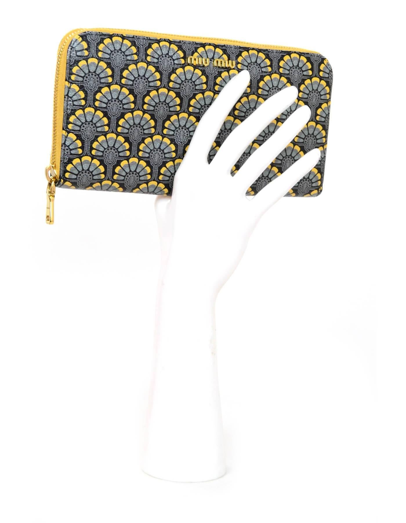 Miu Miu Blue & Yellow Floral Zip Wallet

Made In: Turkey
Color: Blue, yellow
Hardware: Goldtone
Materials: Coated canvas, metal
Lining: Yellow and print textile
Closure/Opening: Zip top
Exterior Pockets: None
Interior Pockets: Twelve card slots, two