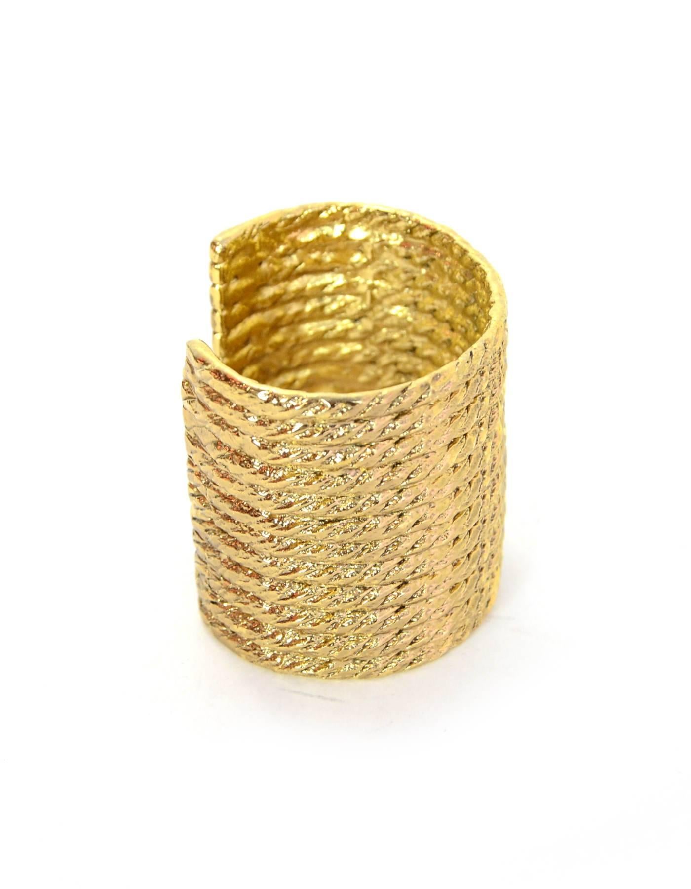 YSL Goldtone Cuff Bracelet

Color: Gold
Hardware: Goldtone
Materials: Metal
Closure/Opening: Open
Stamp: YSL
Overall Condition: Excellent pre-owned conditon, some tarnishing throughout

Measurements:
Diamater: 2.25