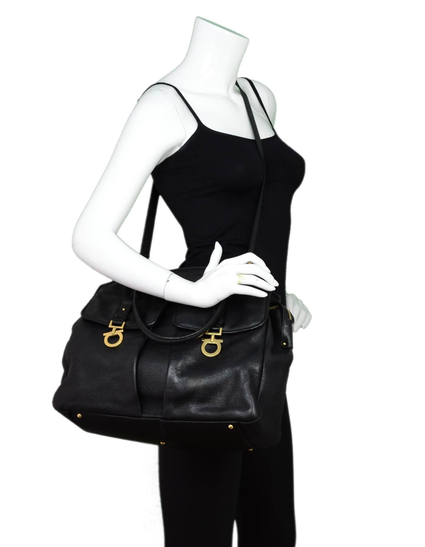Salvatore Ferragamo Black Leather Satchel Bag

Made In: Italy
Color: Black
Hardware: Goldtone
Materials: Leather, metal
Lining: Brown textile
Closure/Opening: Zip top
Exterior Pockets: Two front pockets, back pocket
Interior Pockets: Zip pocket, two