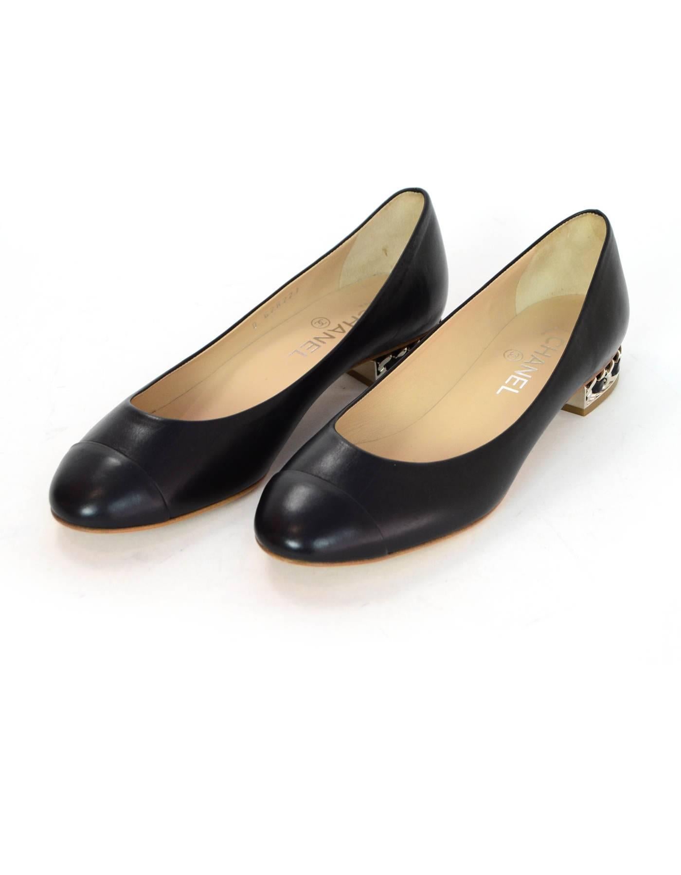 Chanel Black Leather Flats with Chain Heels Sz 39 NIB

Made In: Italy
Color: Black
Materials: Leather, metal
Closure/Opening: Slide on
Sole Stamp: CC 39 Made in Italy
Retail Price: $995 + tax
Overall Condition: Excellent pre-owned condition -