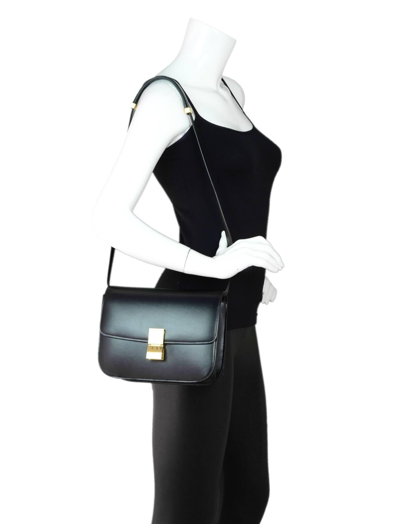 Celine Black Calfskin Medium Box Bag

Made In: Italy
Color: Black
Hardware: Goldtone
Materials: Leather, metal
Lining: Black textile
Closure/Opening: Flap top with push lock closure
Exterior Pockets: None
Interior Pockets: Two compartments with two